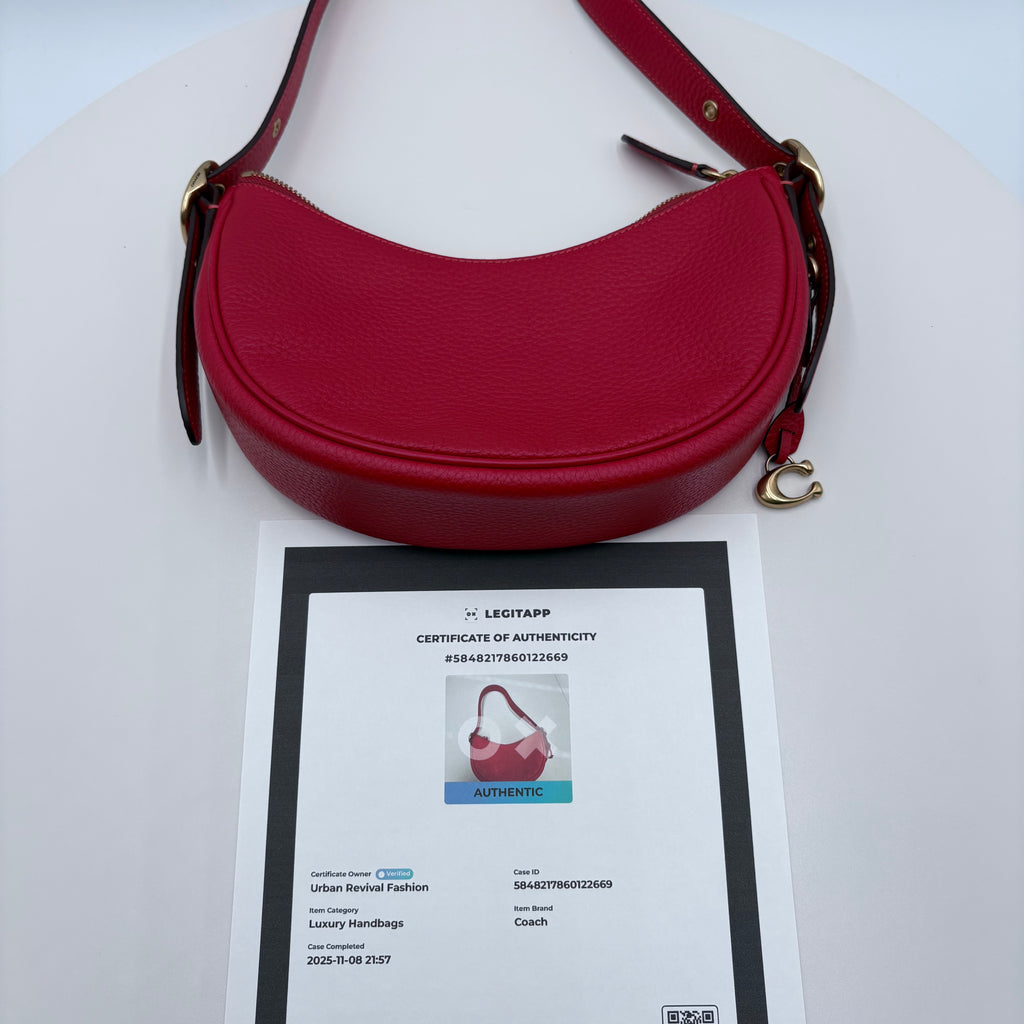 Red handbag with a certificate of authenticity on a white background