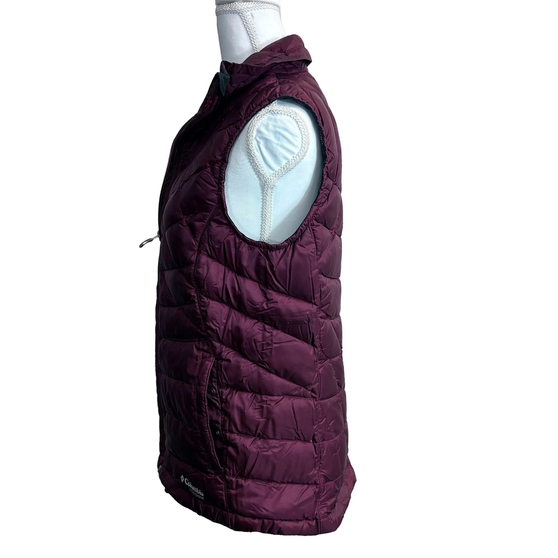 Maroon quilted vest on a mannequin against a white background