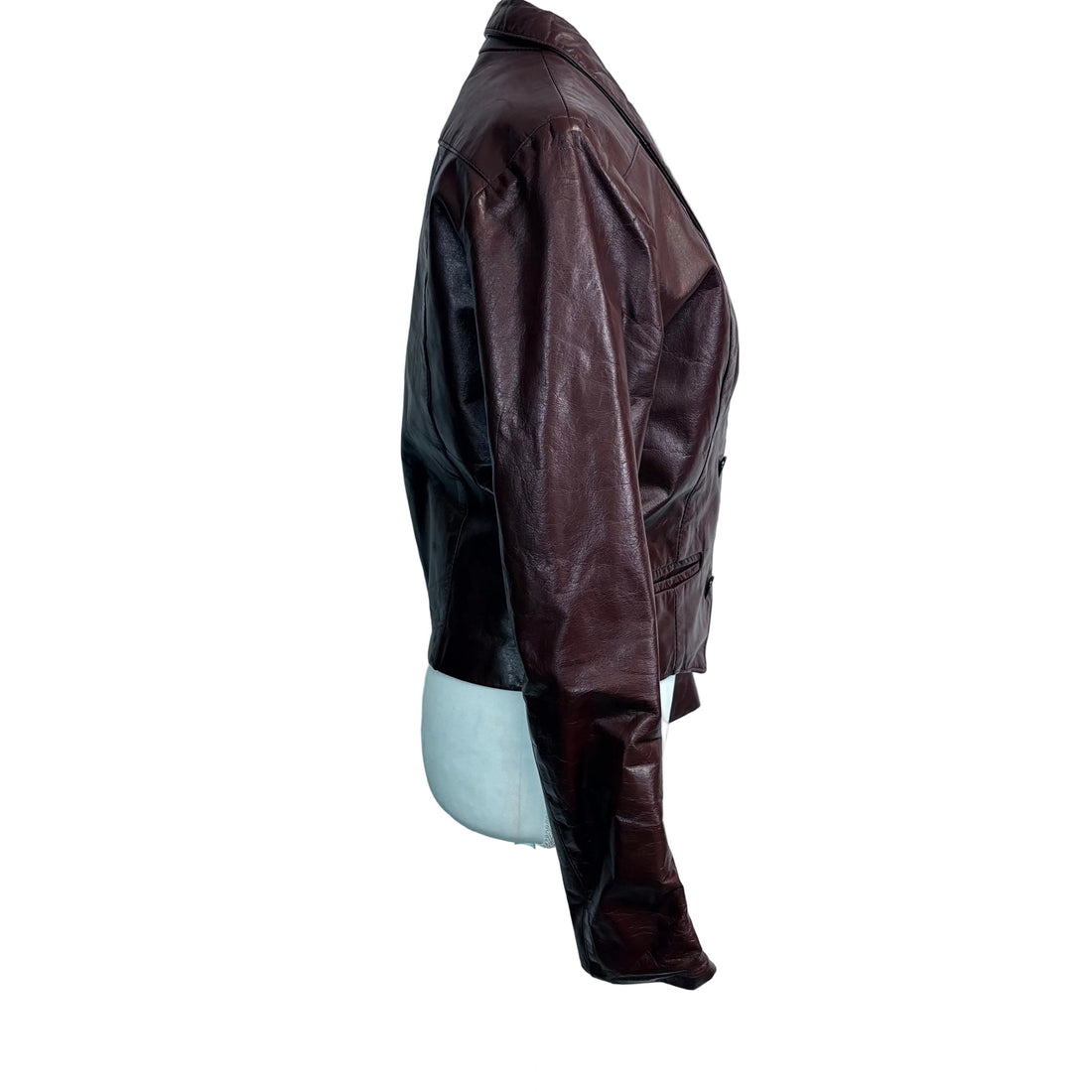 Brown leather jacket on a mannequin against a white background