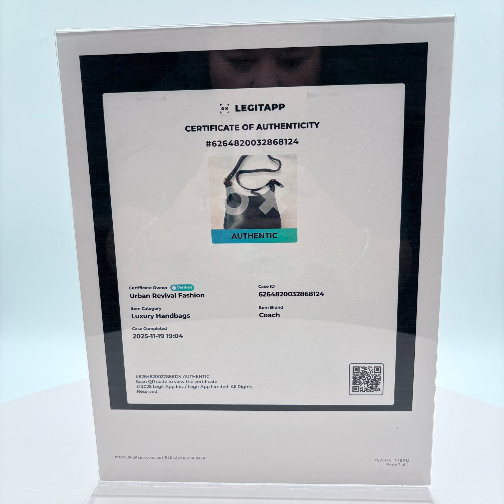 Certificate of Authenticity from LEGITAPP displayed on a stand with a light blue background.
