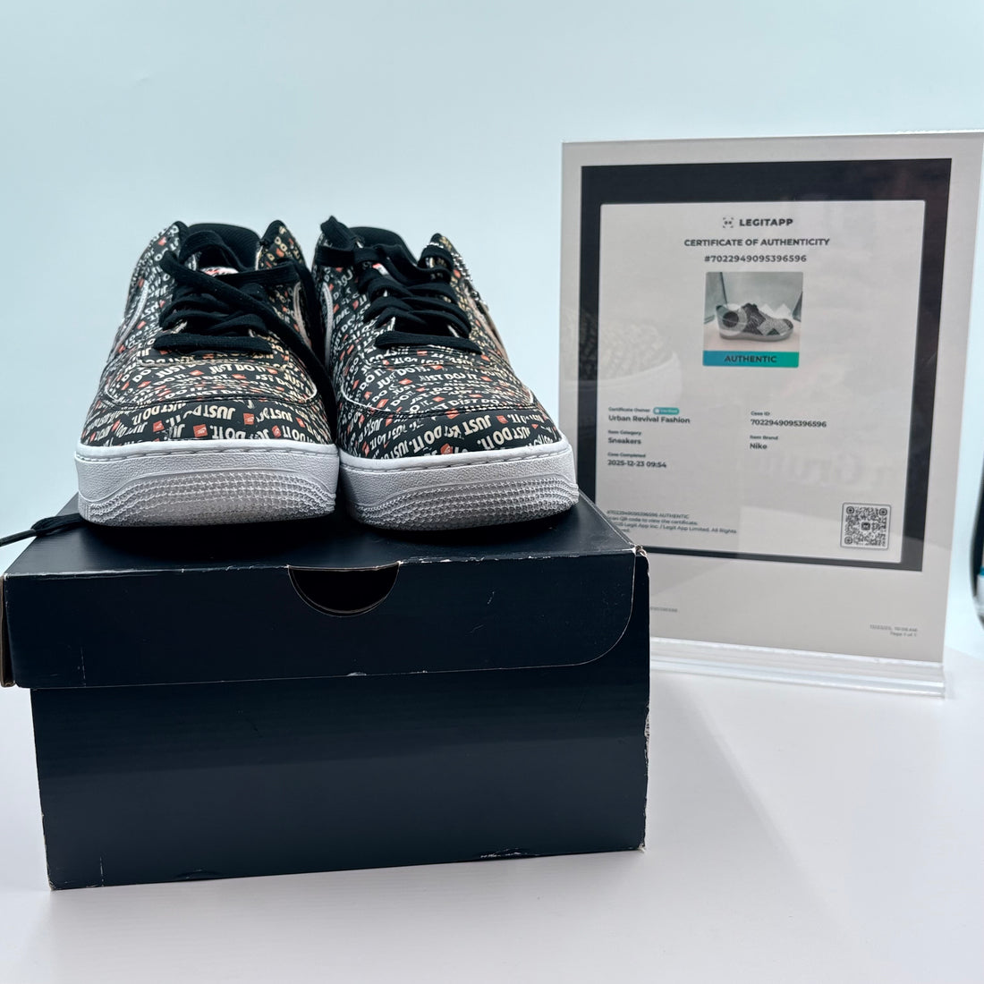 Pair of Nike sneakers with text pattern on a white background