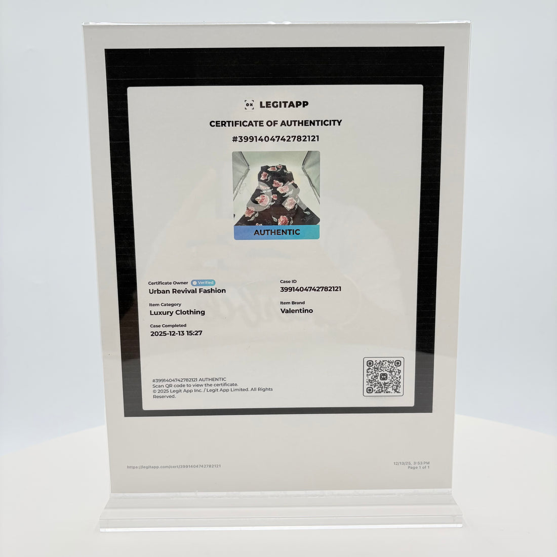 Black dress with pink floral patterns on a white background