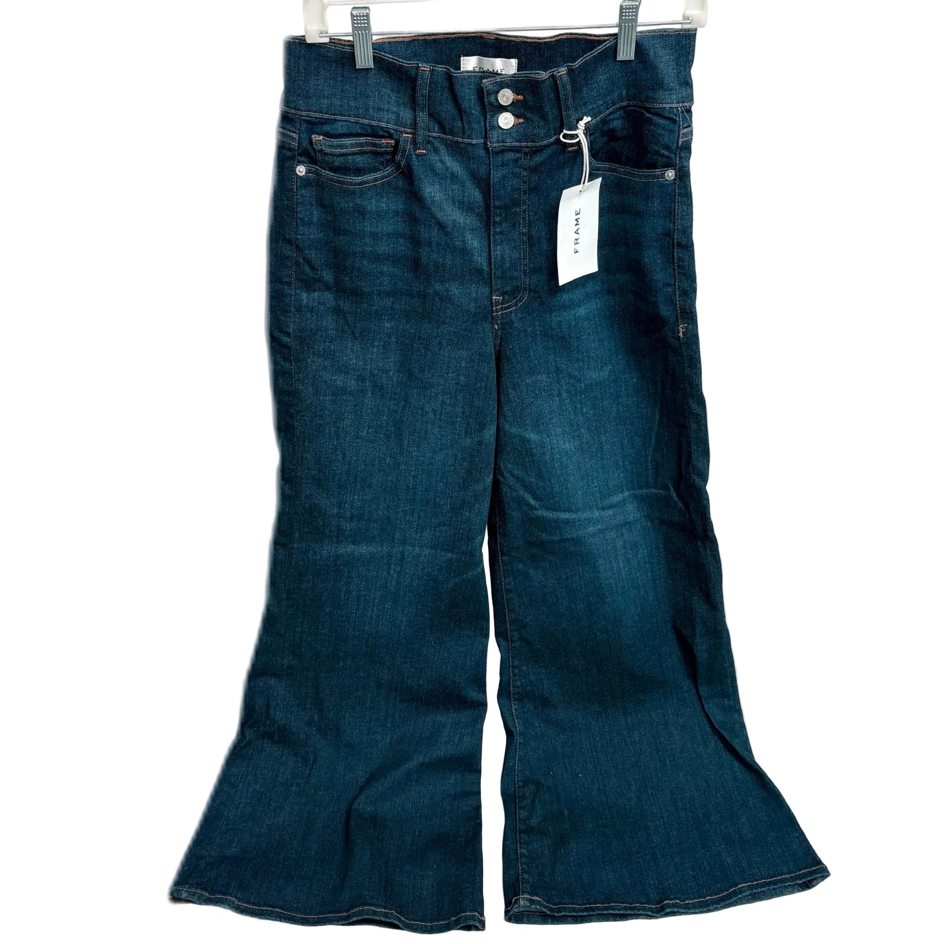 Blue flared jeans with a tag on a white background