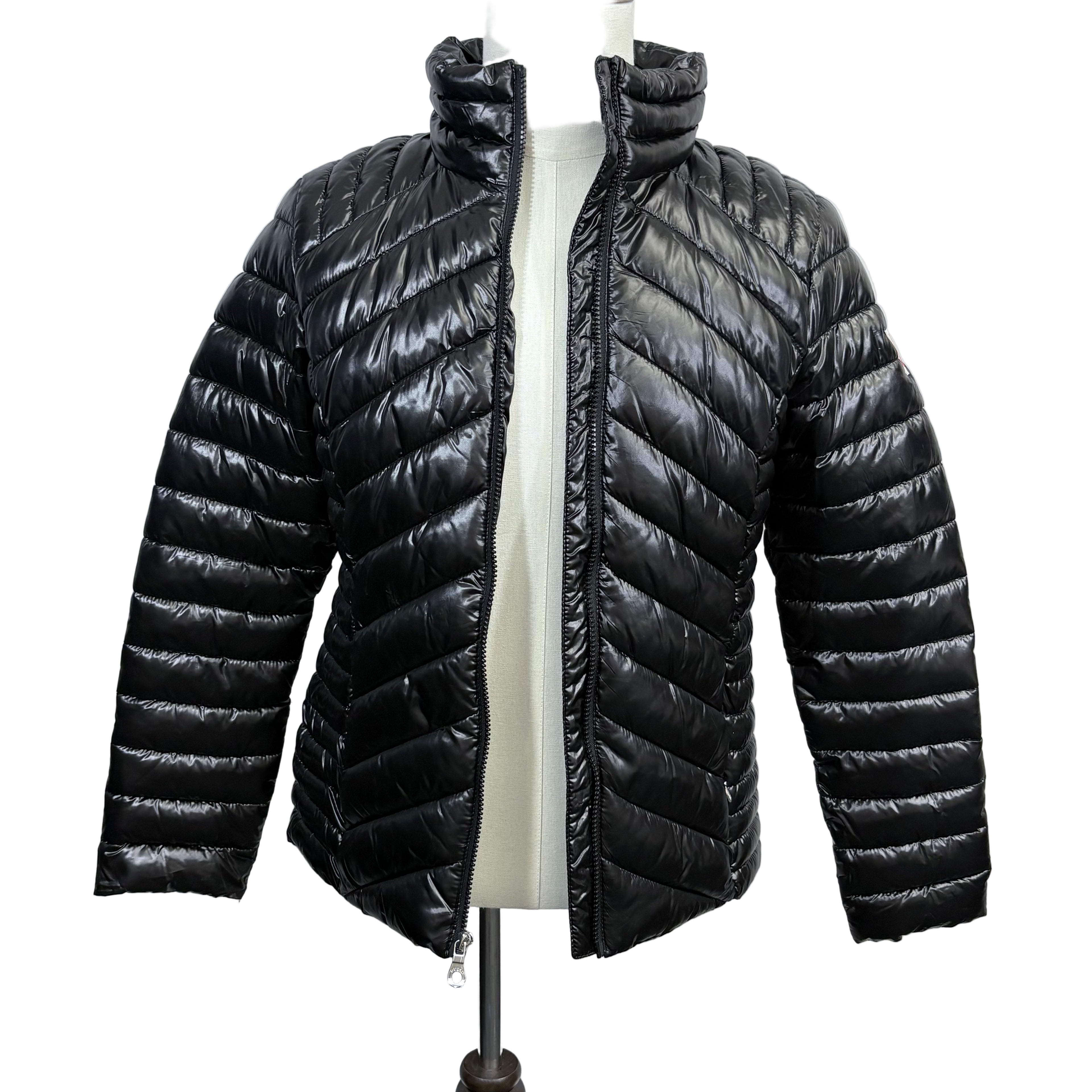 Black puffer jacket on a mannequin against a white background