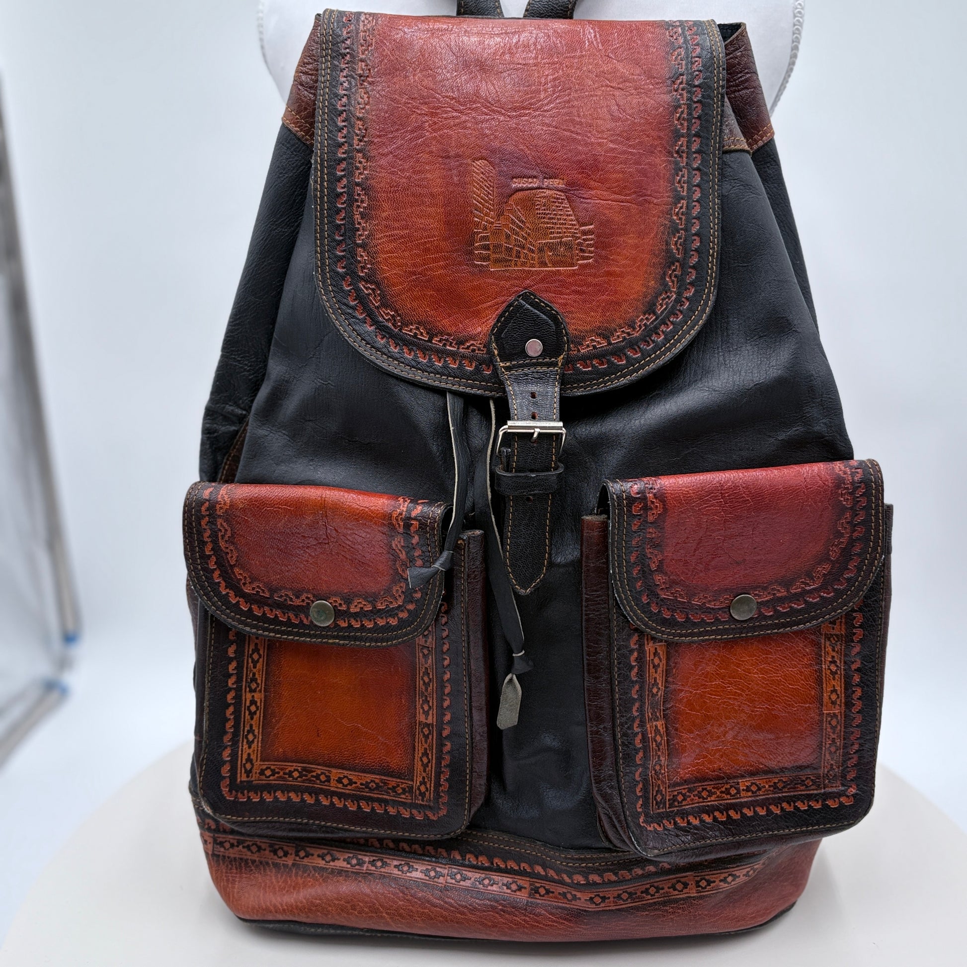 Backpack with brown leather accents on a white background