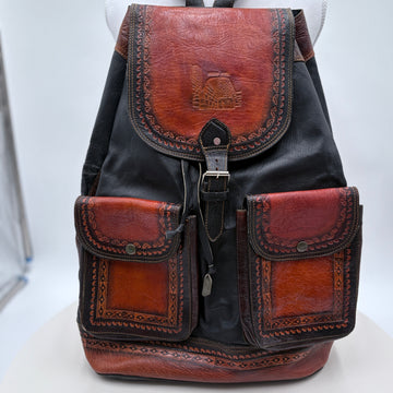 Backpack with brown leather accents on a white background