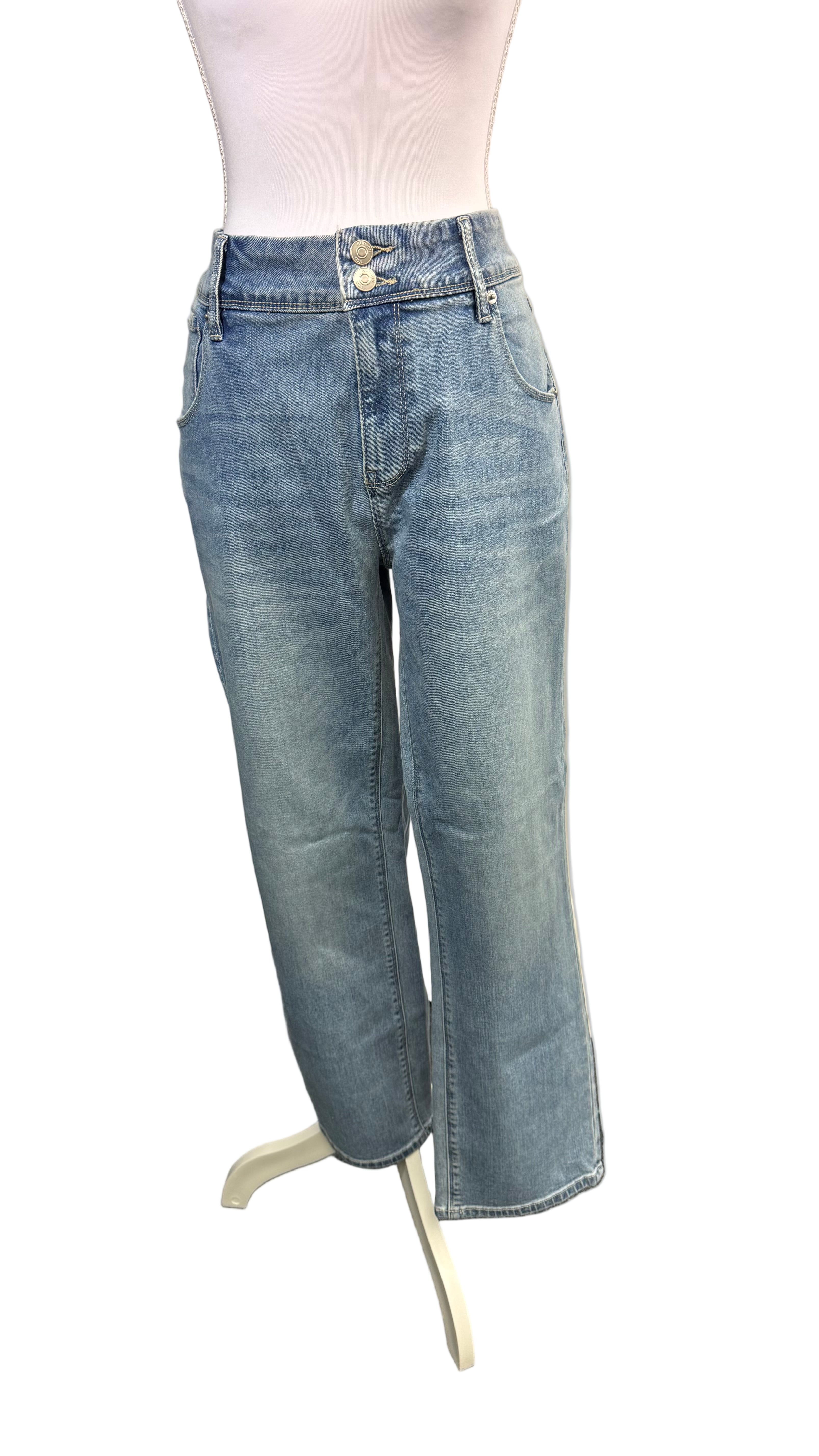 Light blue jeans on a mannequin against a plain background