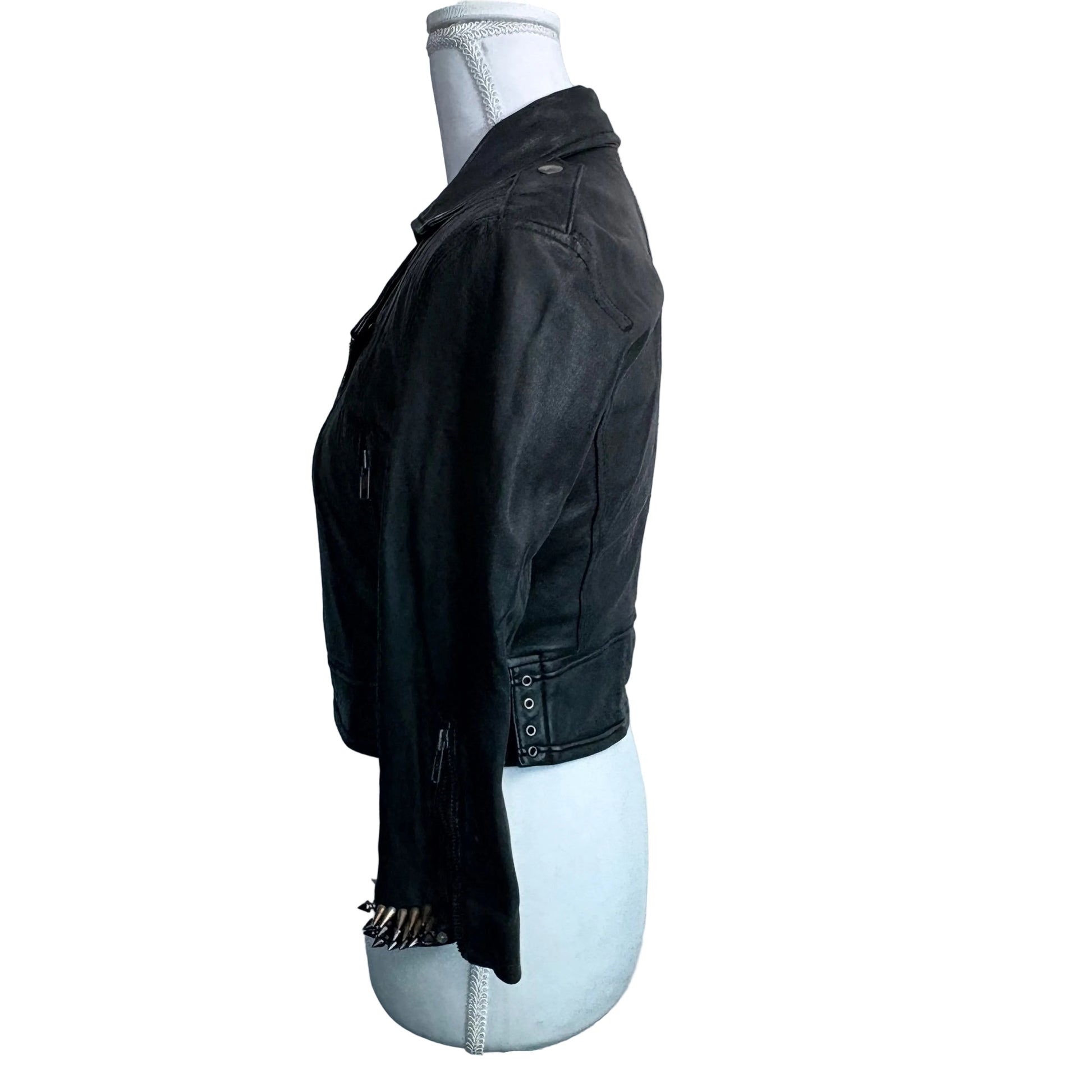 Black jacket on a mannequin against a plain background