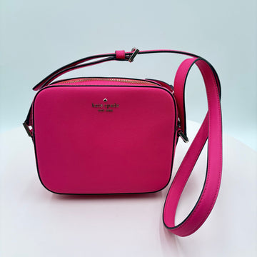 Pink handbag with a matching strap on a light gray background