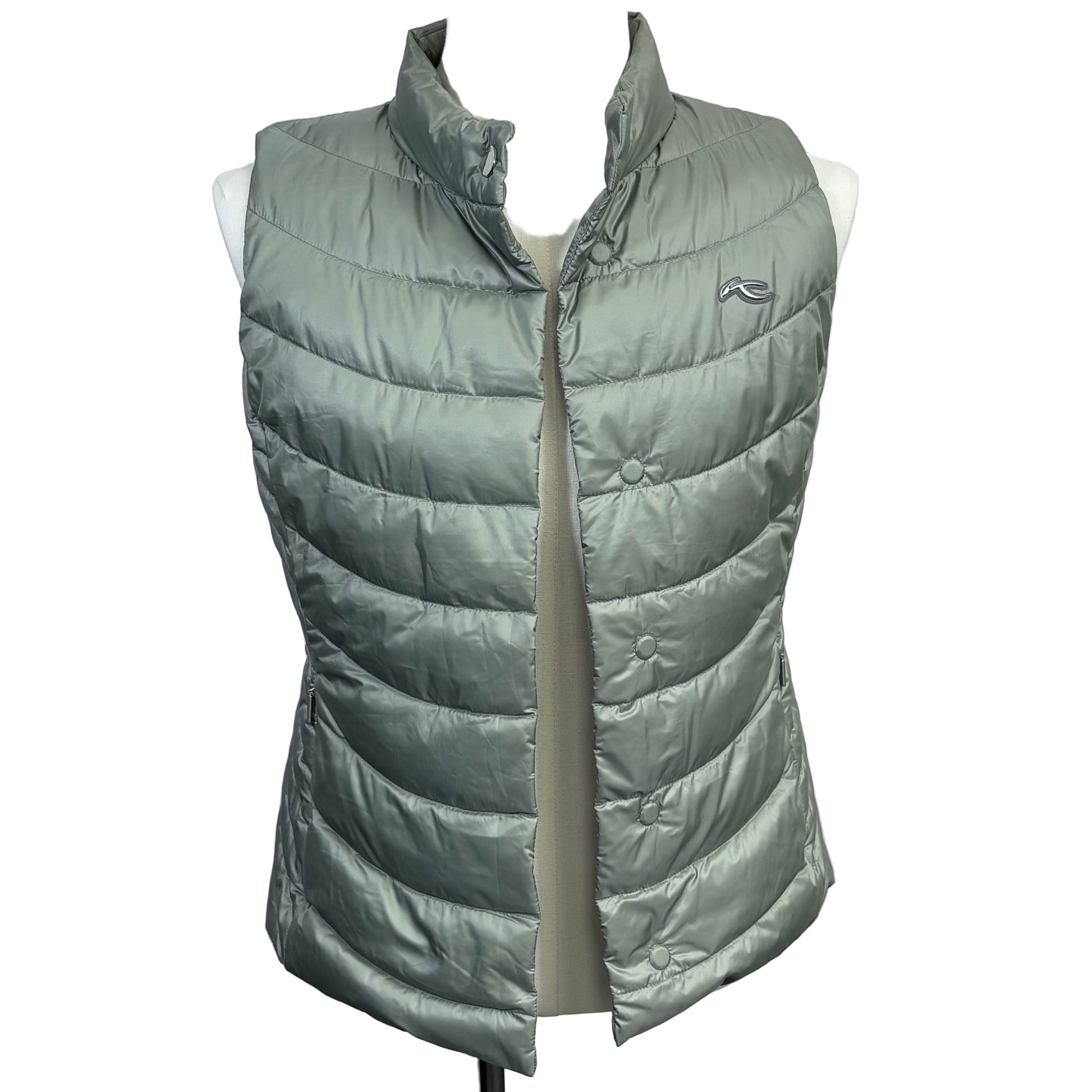 Green puffer vest on a mannequin against a gray background