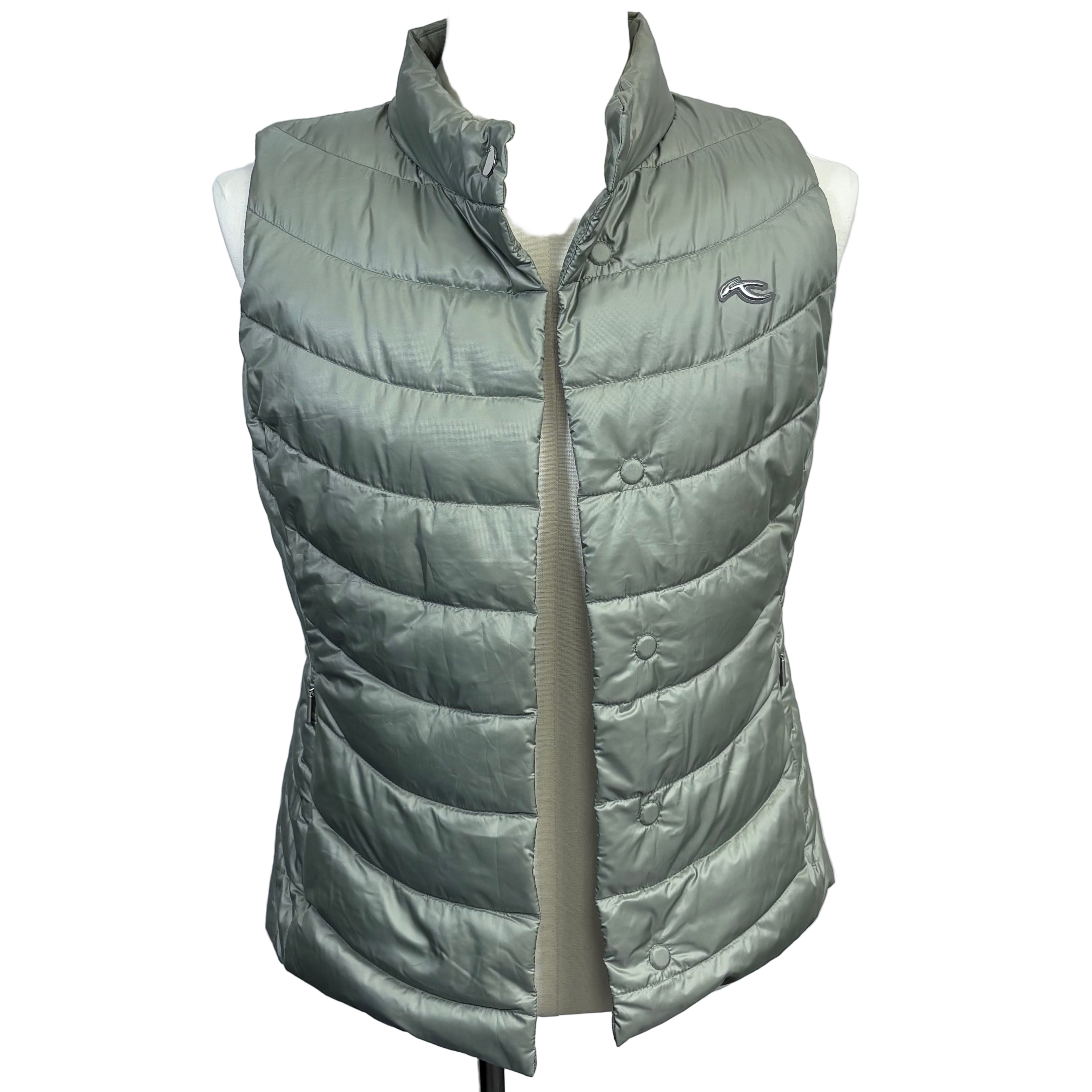 Green puffer vest on a mannequin against a gray background