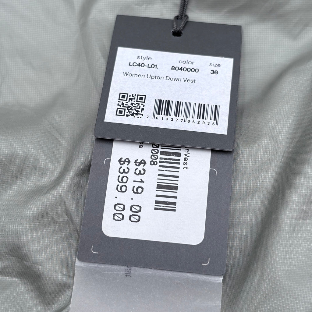 Price tag with QR code and barcode on a gray fabric background