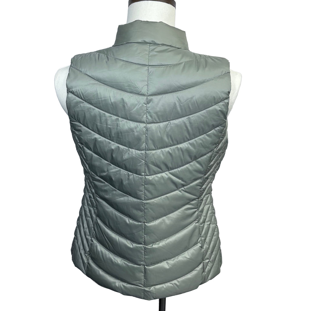 Green quilted vest on a mannequin against a gray background