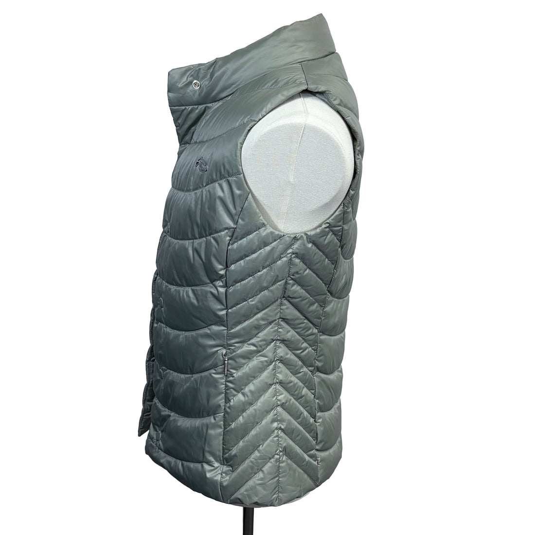 Green puffer vest on a mannequin against a gray background