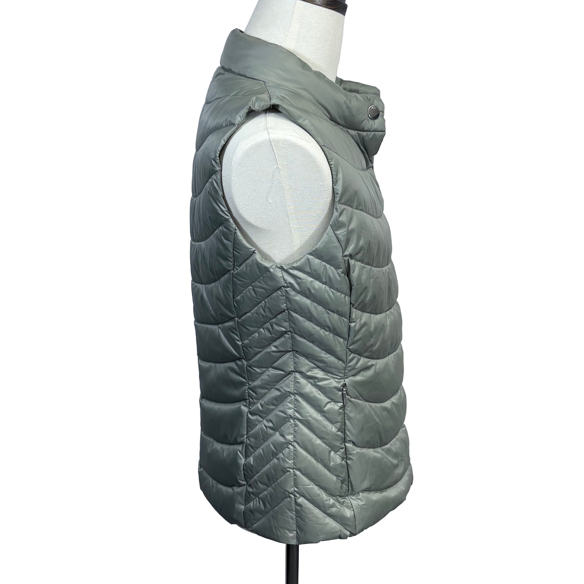 Gray quilted puffer vest on a mannequin against a plain background