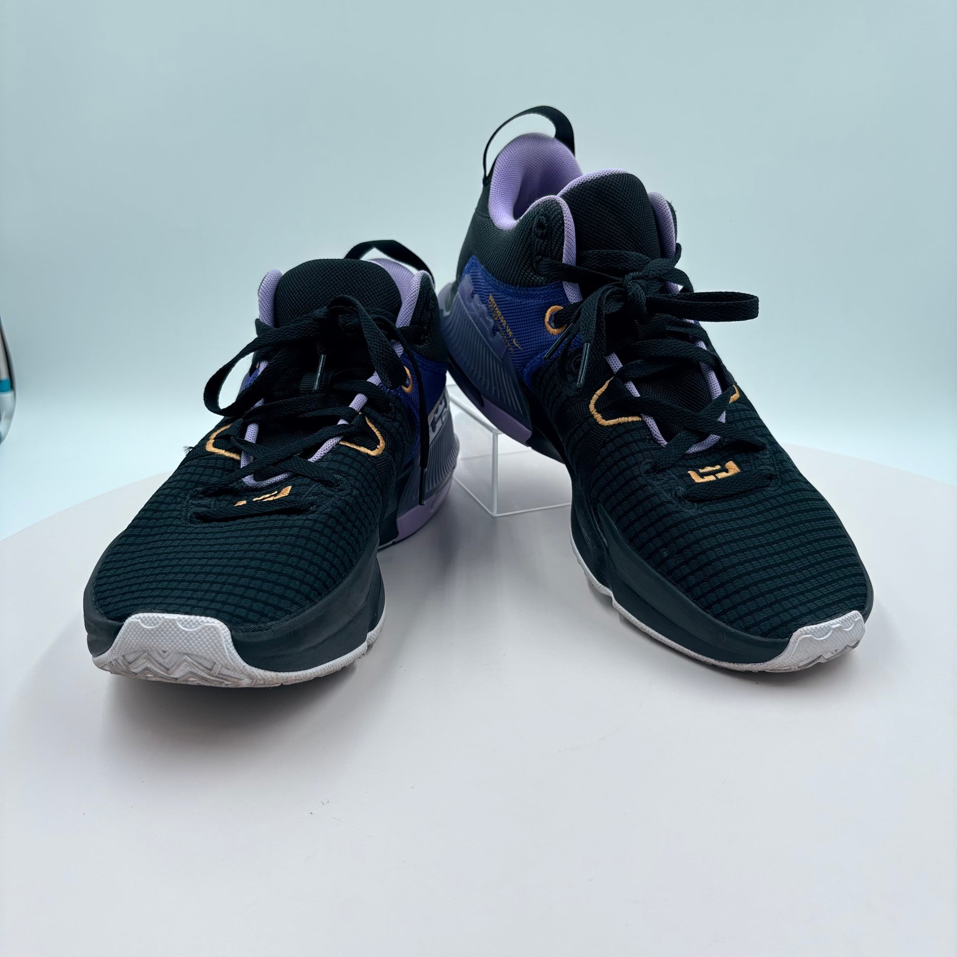 Pair of black and blue athletic shoes on a white background