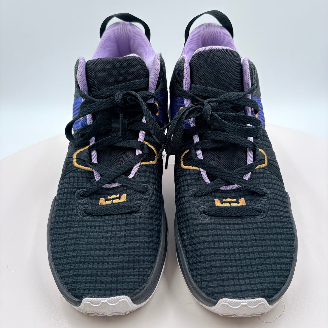 Pair of black and blue athletic shoes on a white background