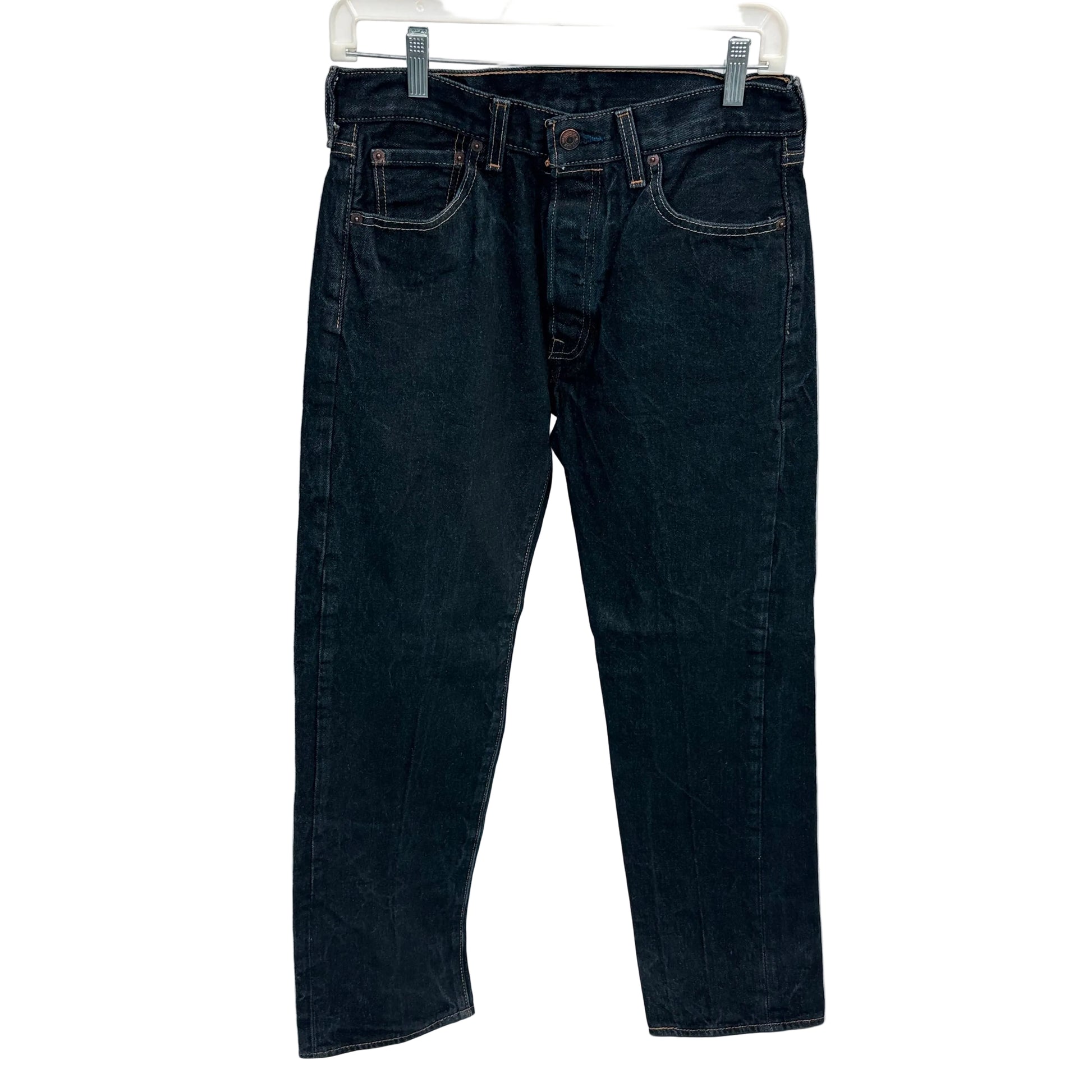 Black jeans on a hanger against a white background