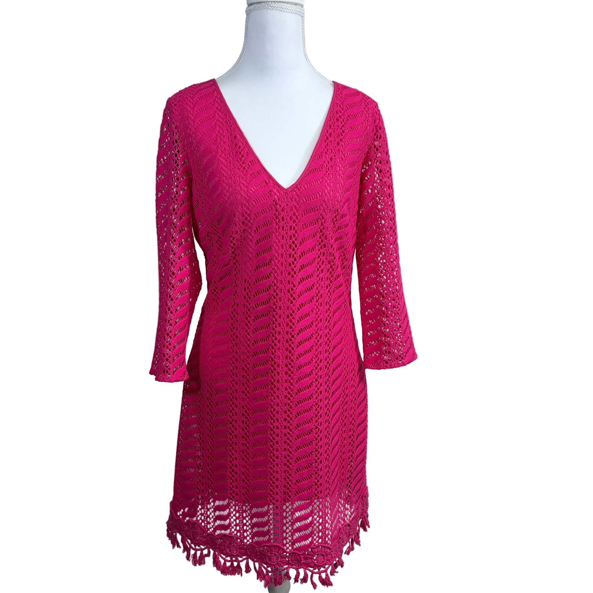Pink lace dress on a mannequin against a white background