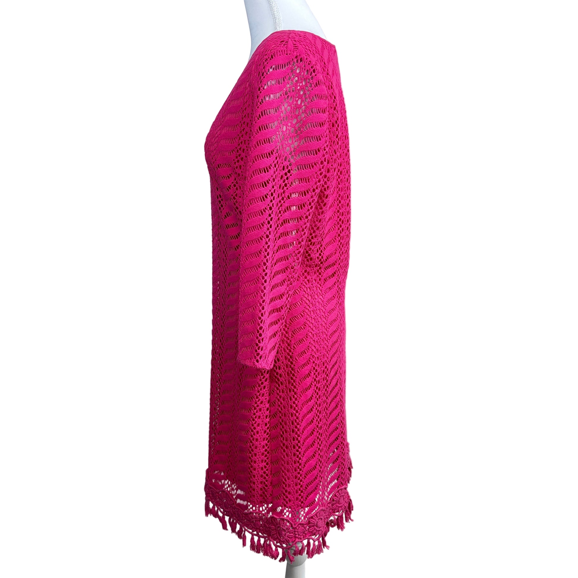 Pink crochet skirt on a mannequin against a white background