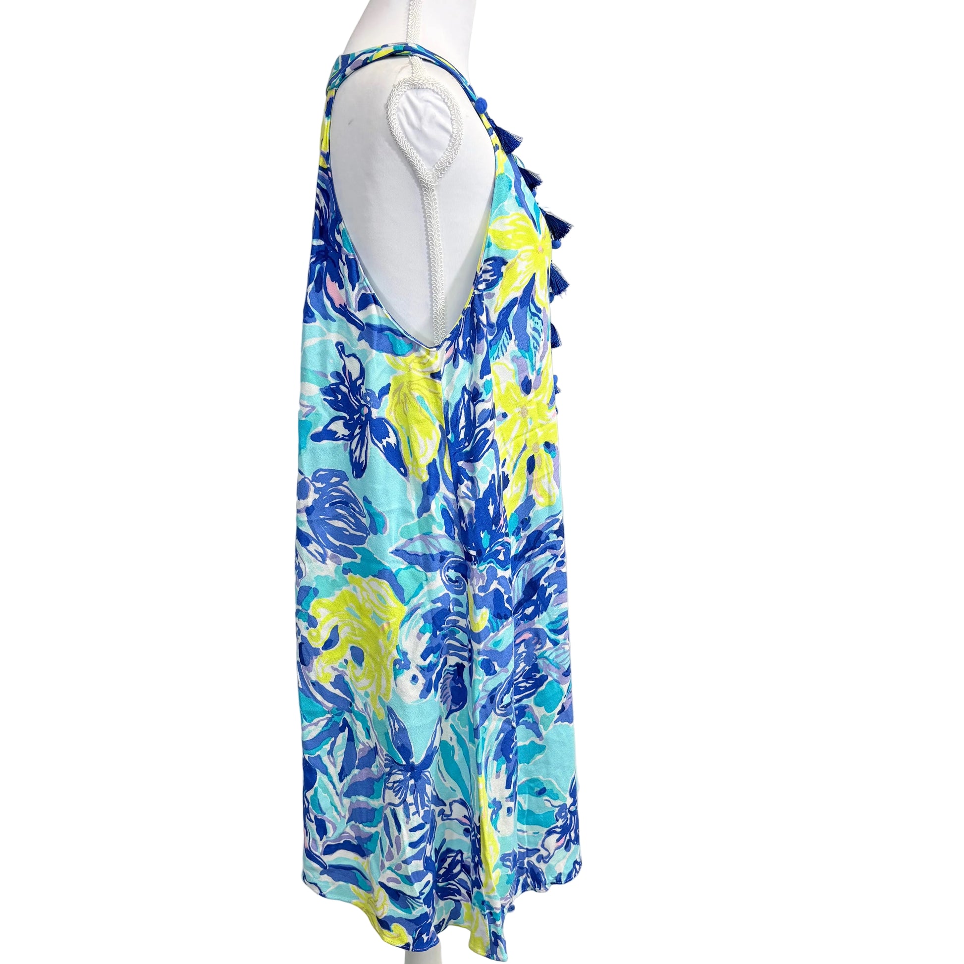 Colorful floral dress on a mannequin against a white background