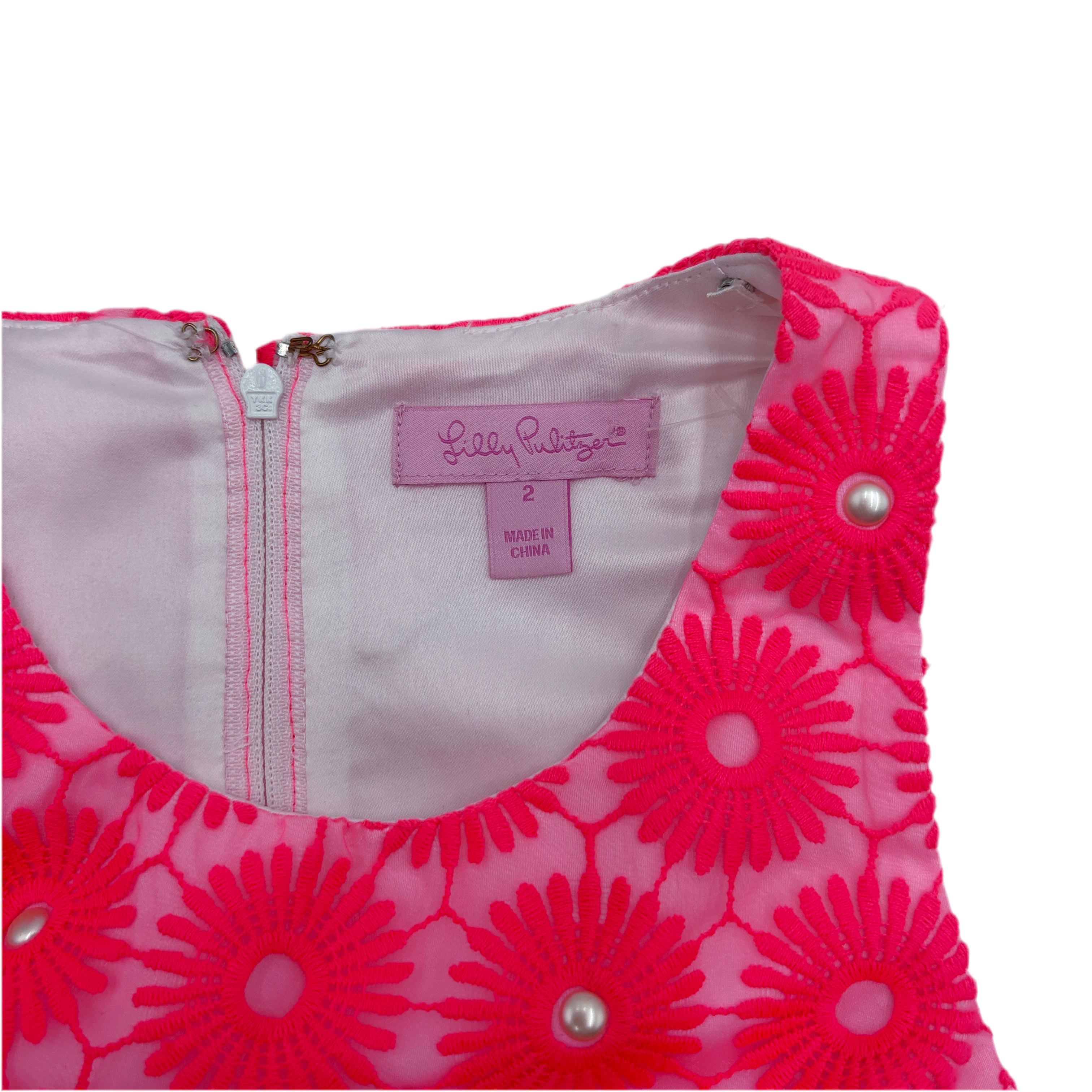 Pink floral dress with a visible size 2 label on a white background