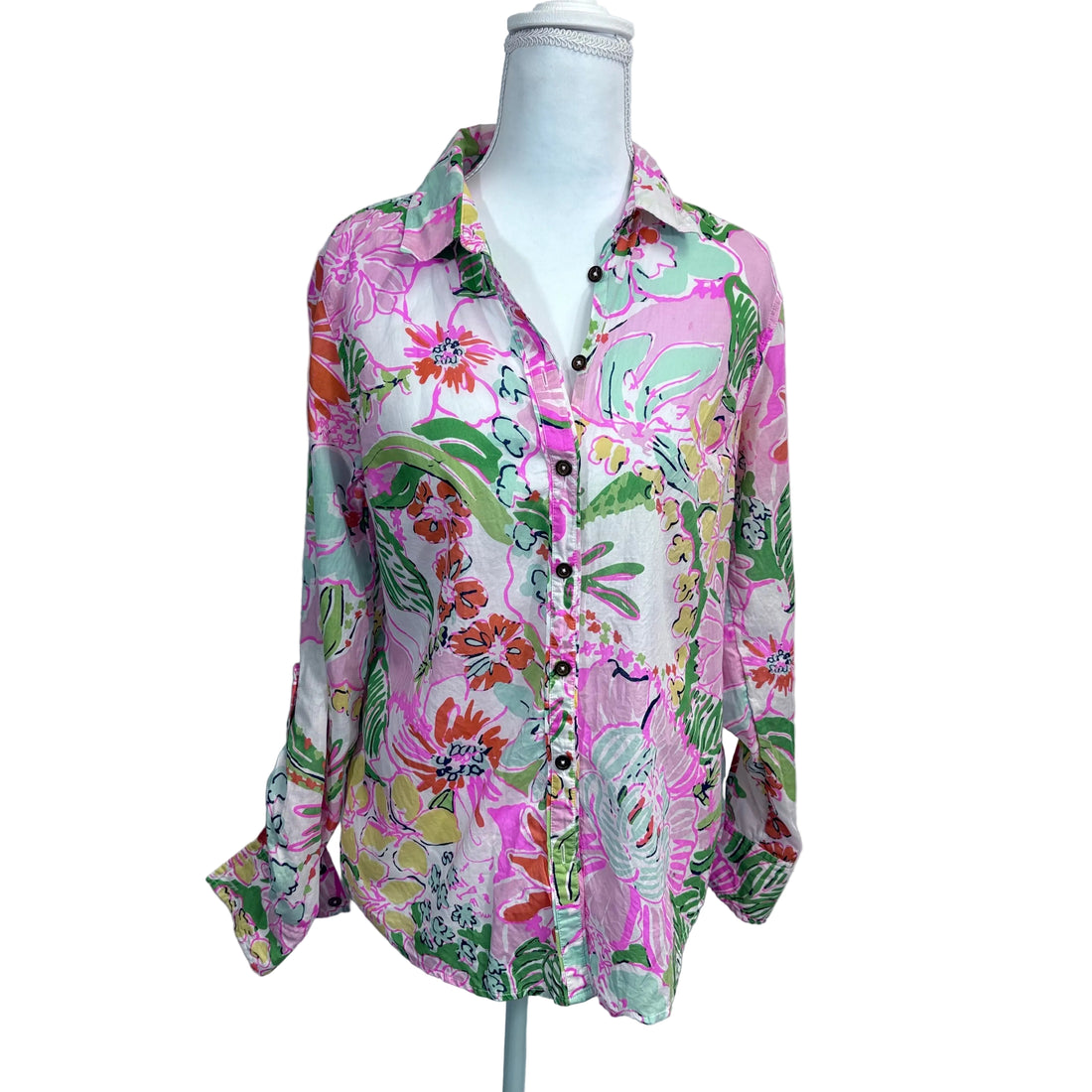 Colorful floral shirt on a mannequin against a plain background