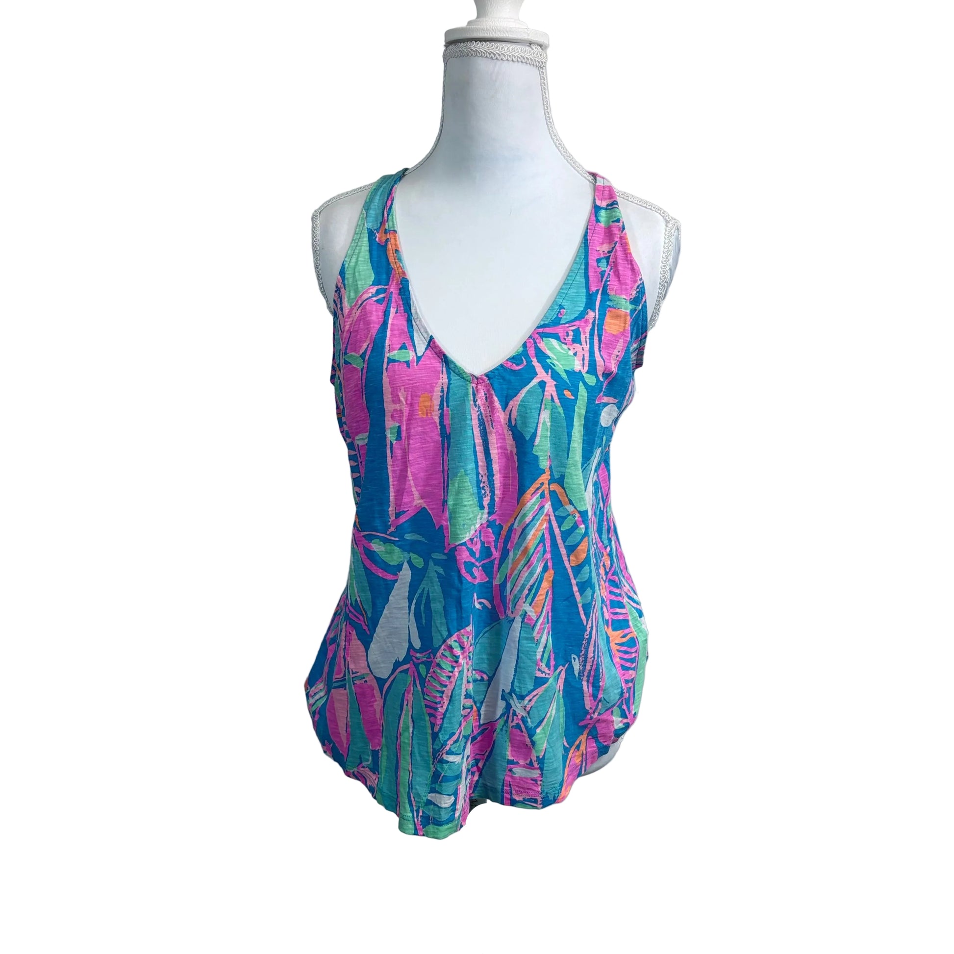 Colorful swimsuit on a mannequin against a plain background