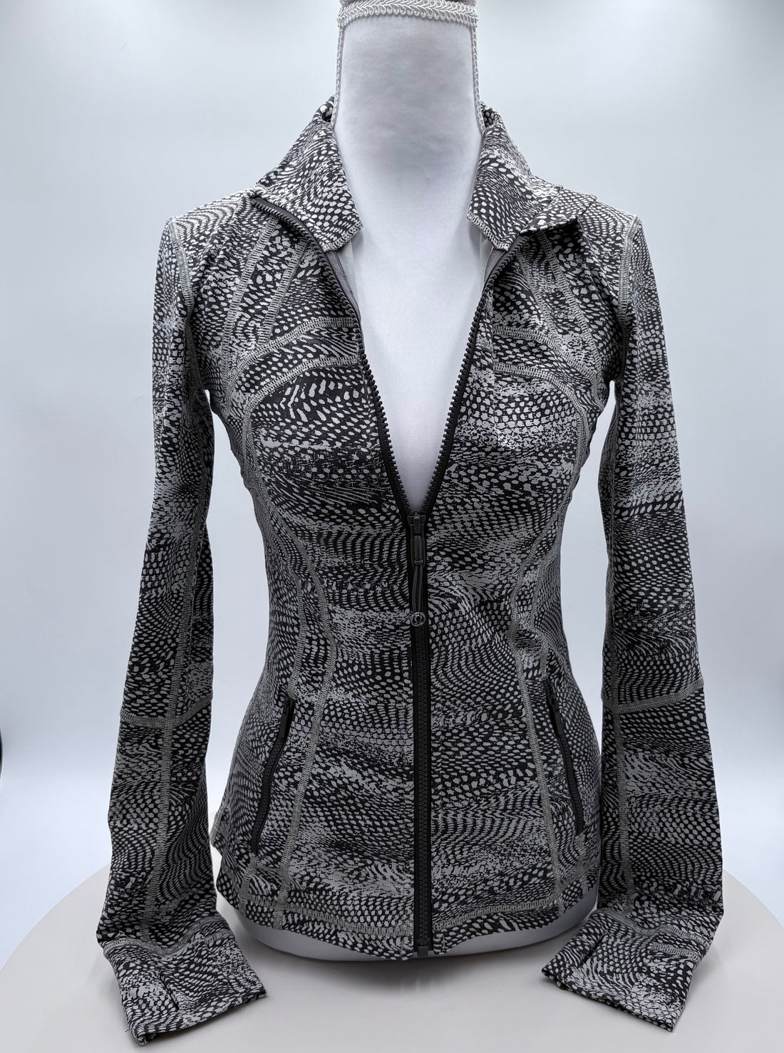 Patterned jacket on a mannequin against a white background
