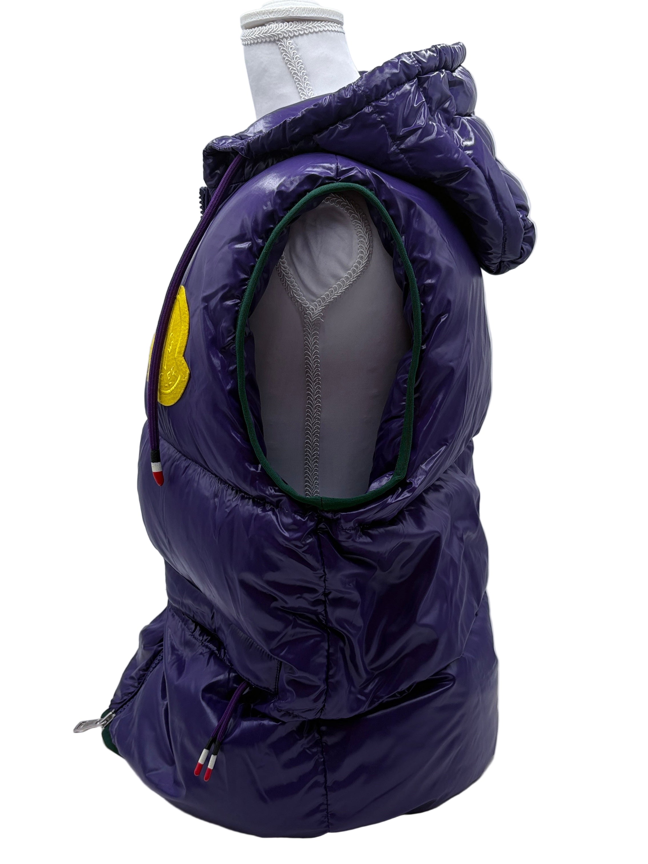 Purple puffer vest on a mannequin against a white background