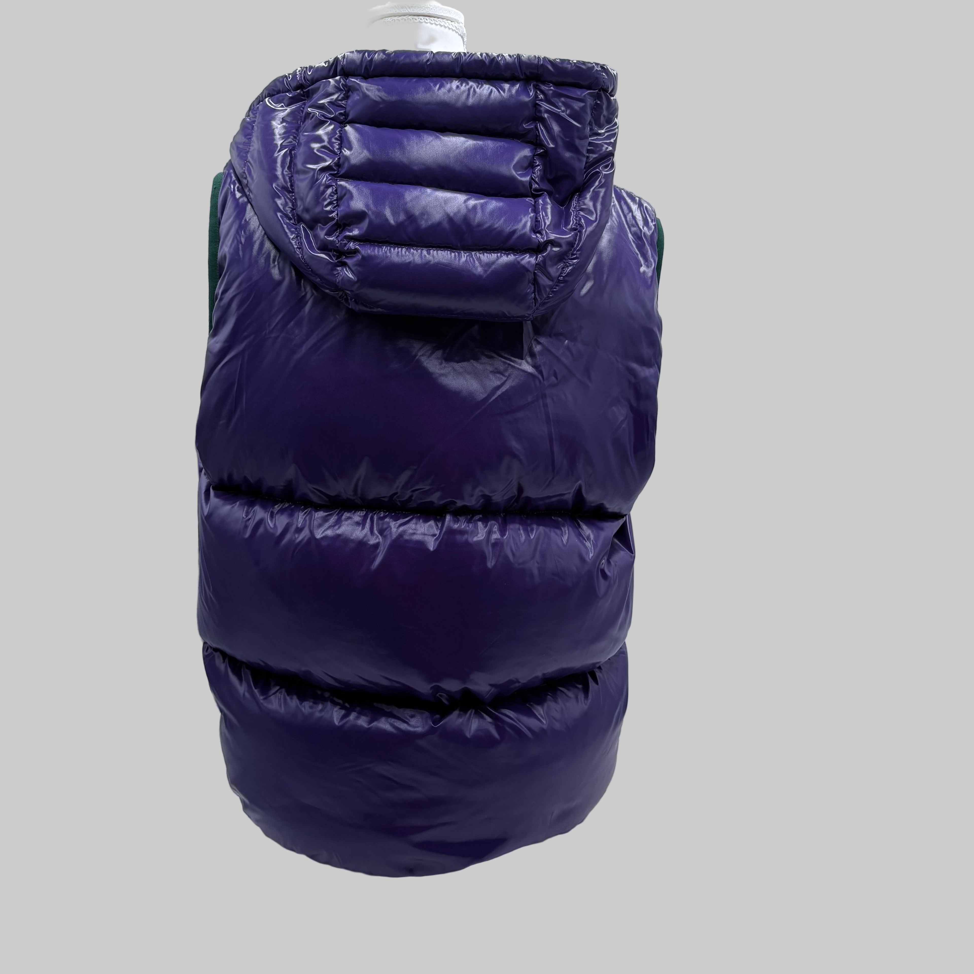 Purple puffer vest back with hood on a mannequin against a grey background