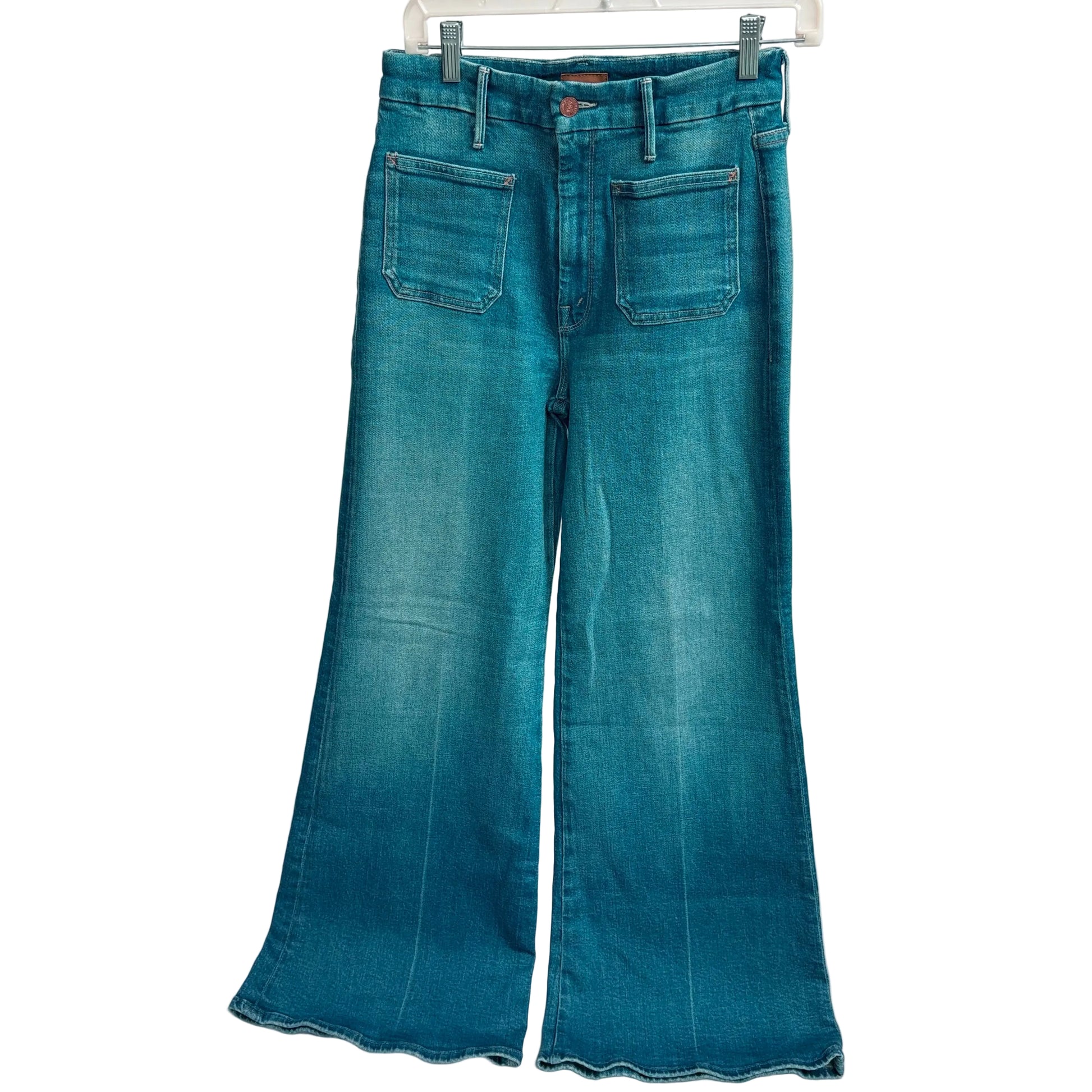 Blue jeans hanging on a white background