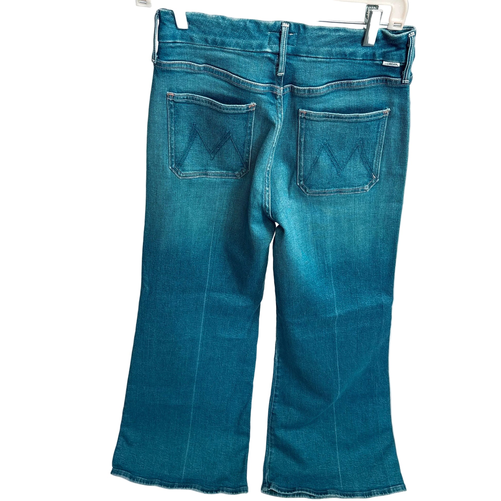 Blue jeans hanging on a white background