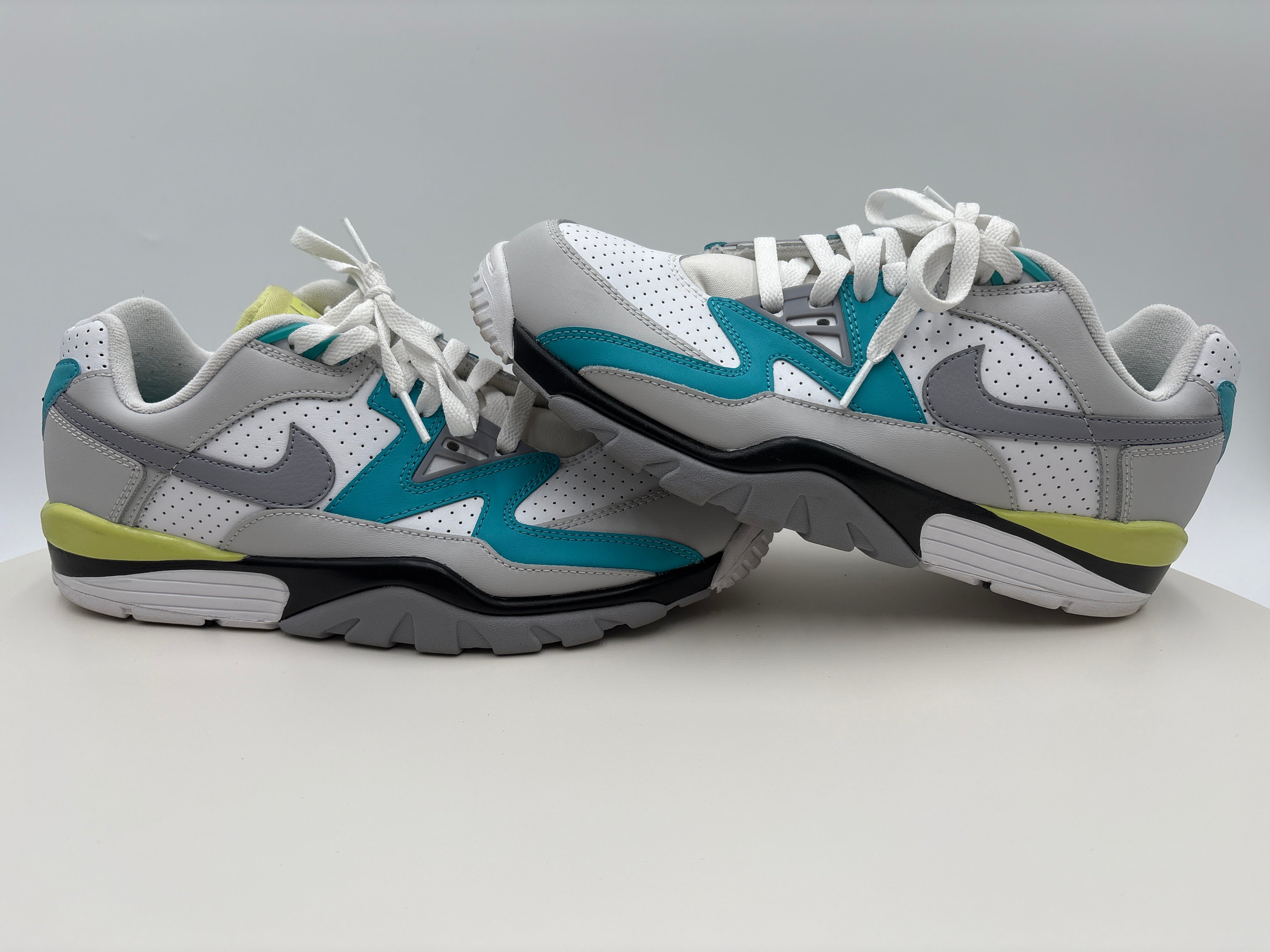 Pair of gray and blue sneakers on a light gray background