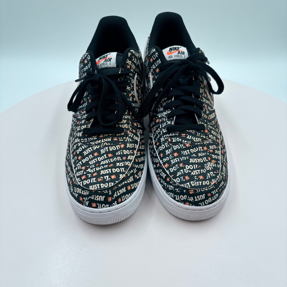 Pair of Nike sneakers with text pattern on a white background