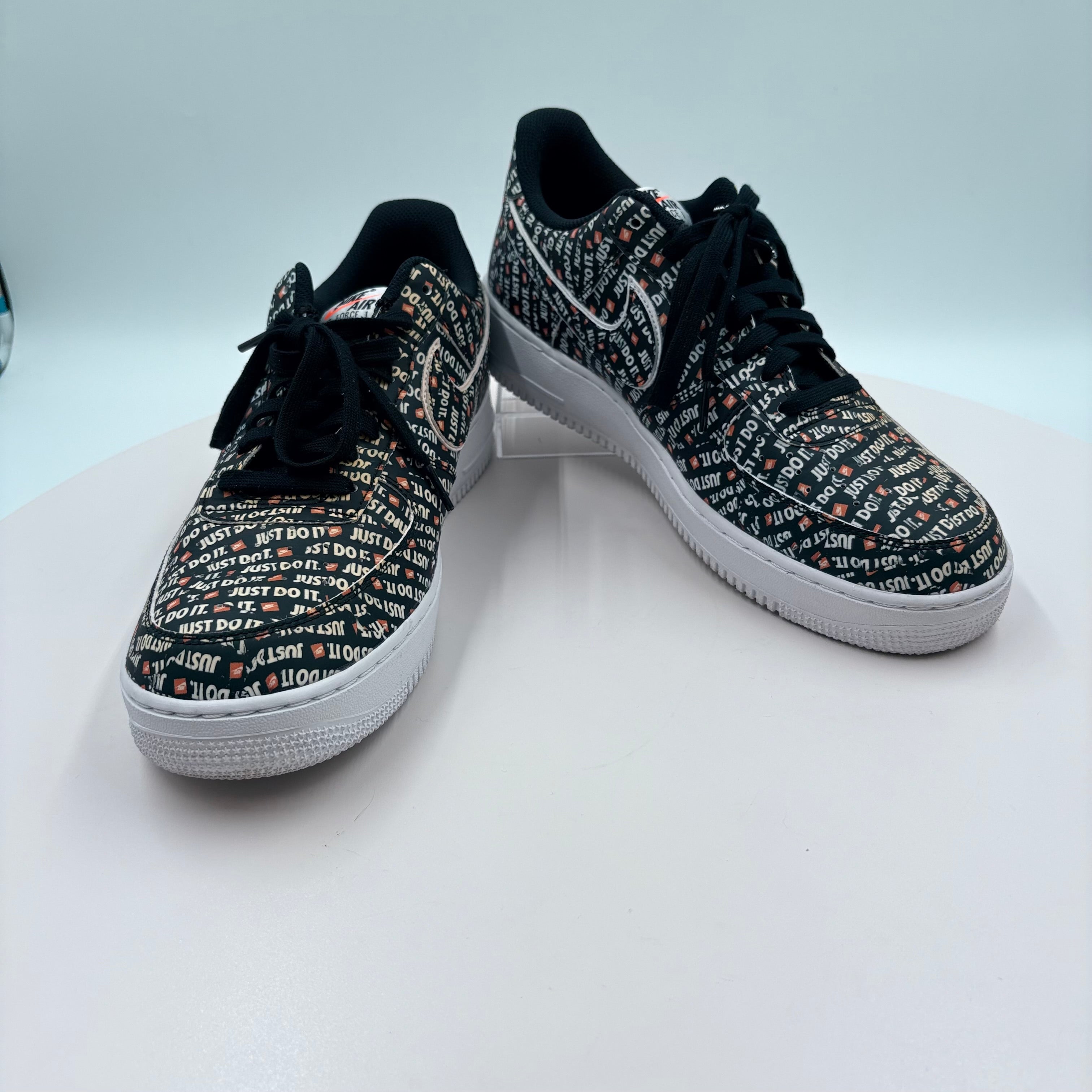 Black sneakers with white text pattern on a white background