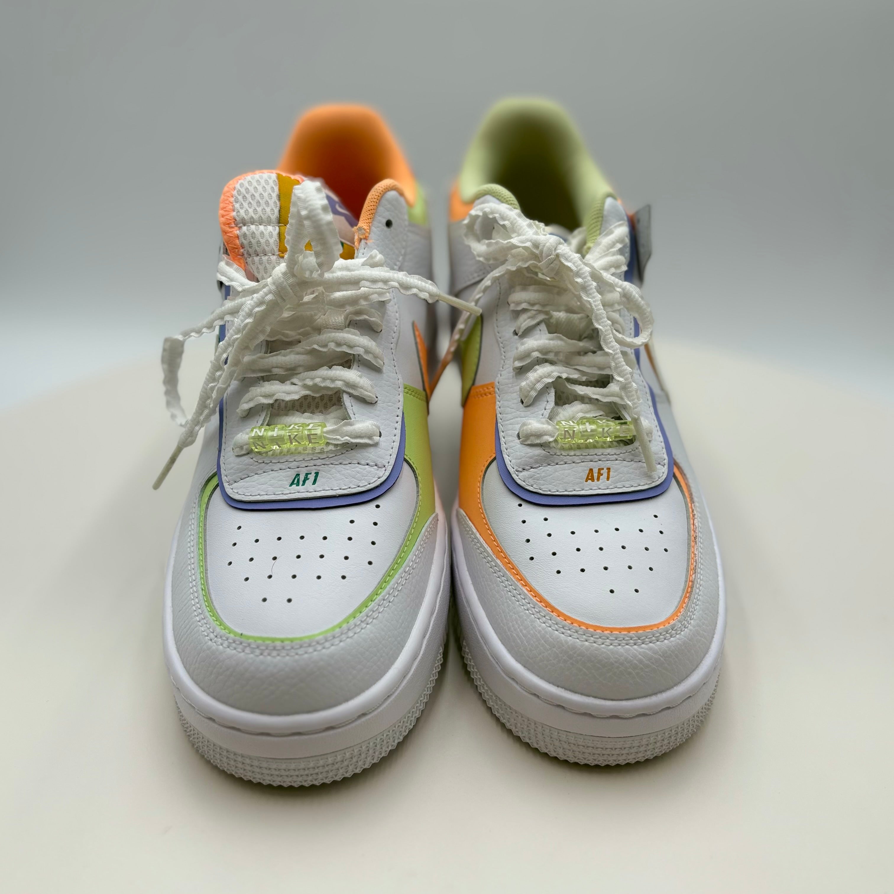 White sneakers with colorful accents on a light gray background