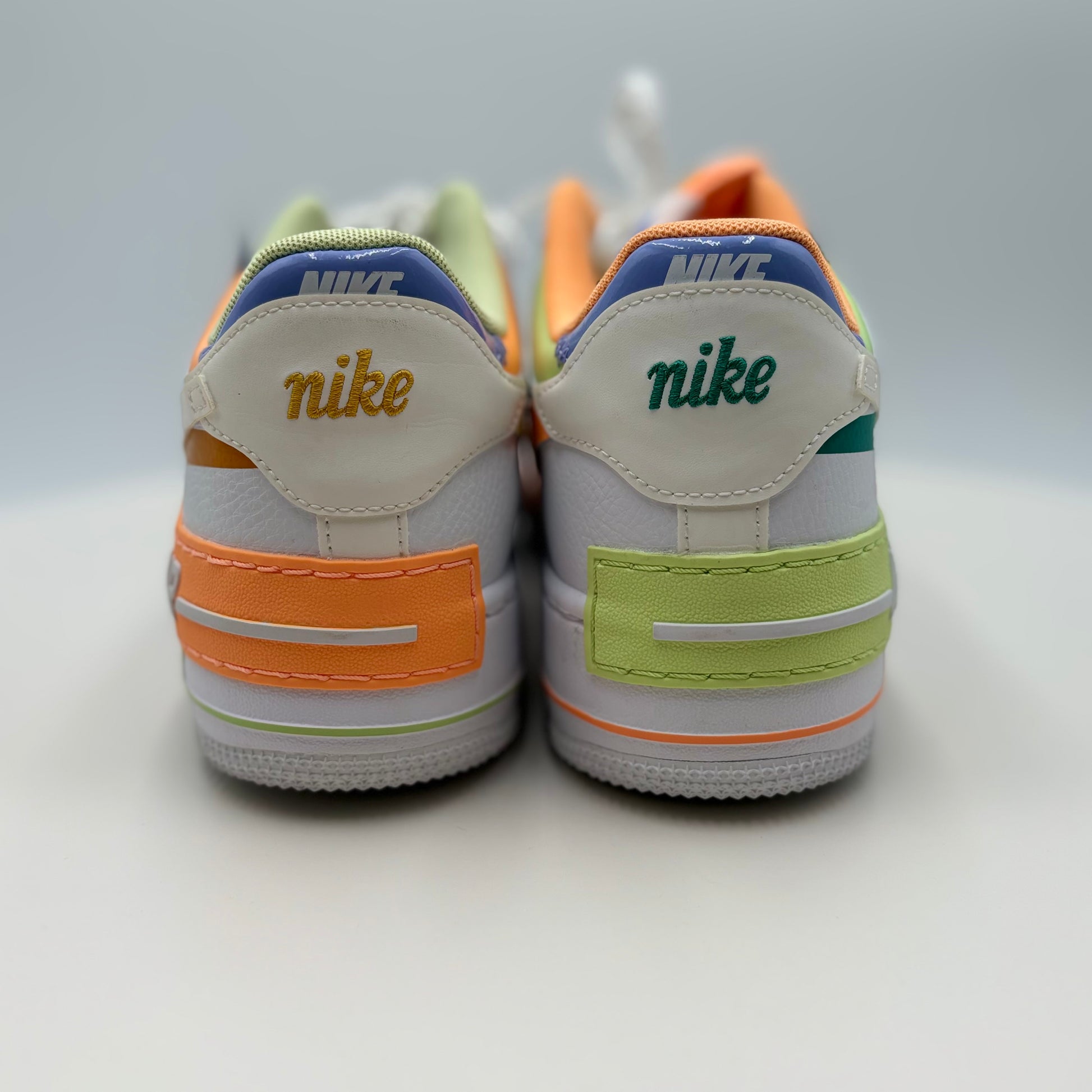 Pair of Nike sneakers with colorful accents on a white background