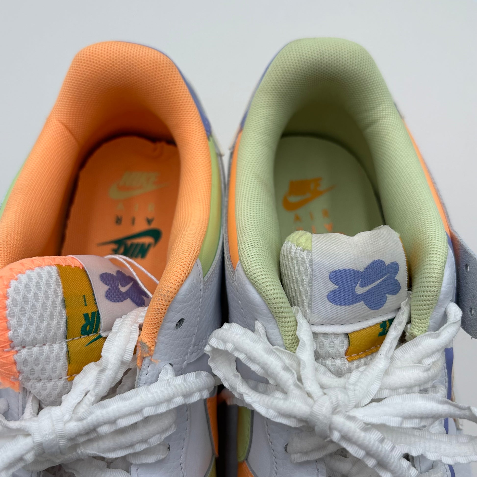 Two pairs of sneakers with different color schemes and brand logos.