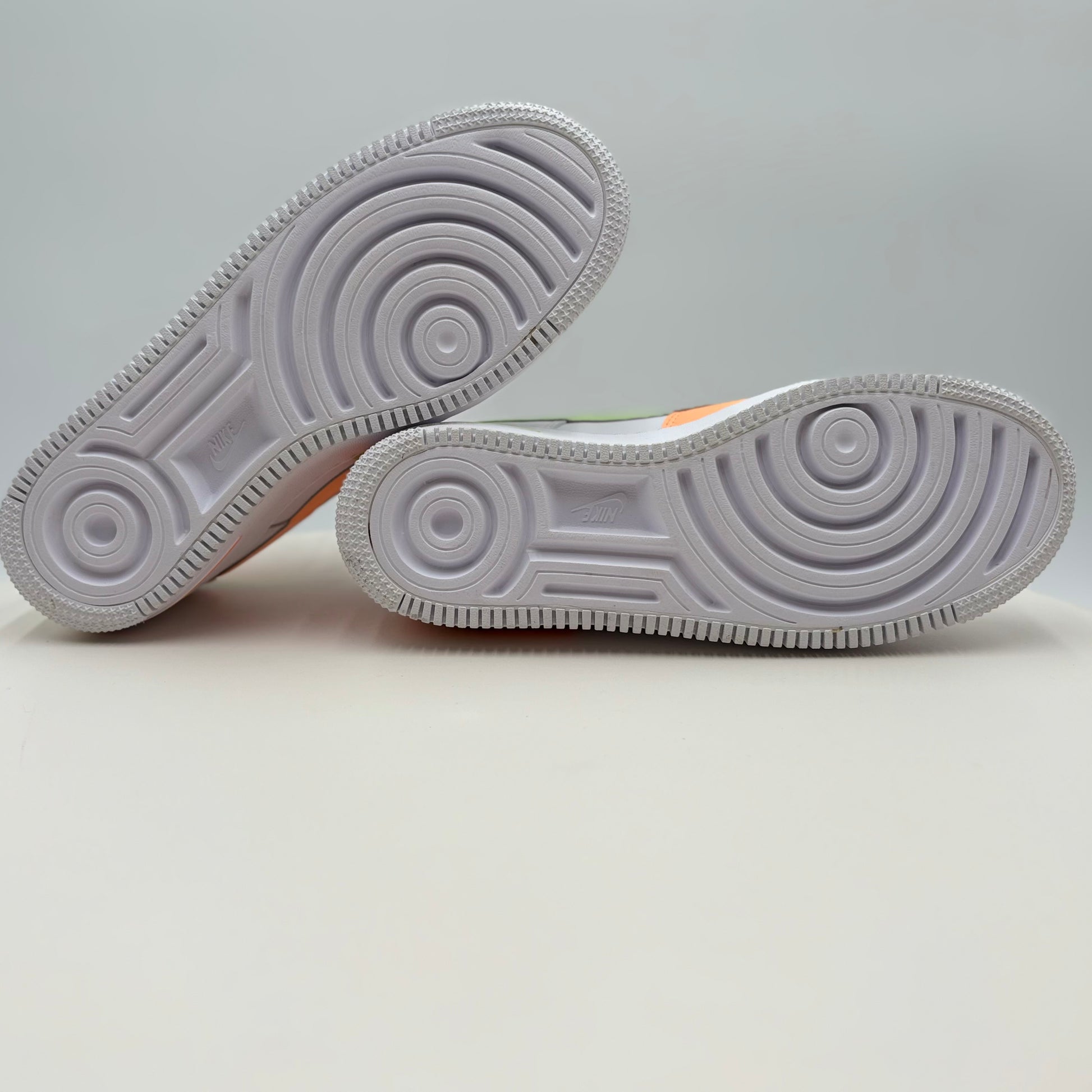 Close-up of a pair of white sneakers with a gray background