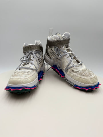 White high-top sneakers with colorful soles on a light gray background