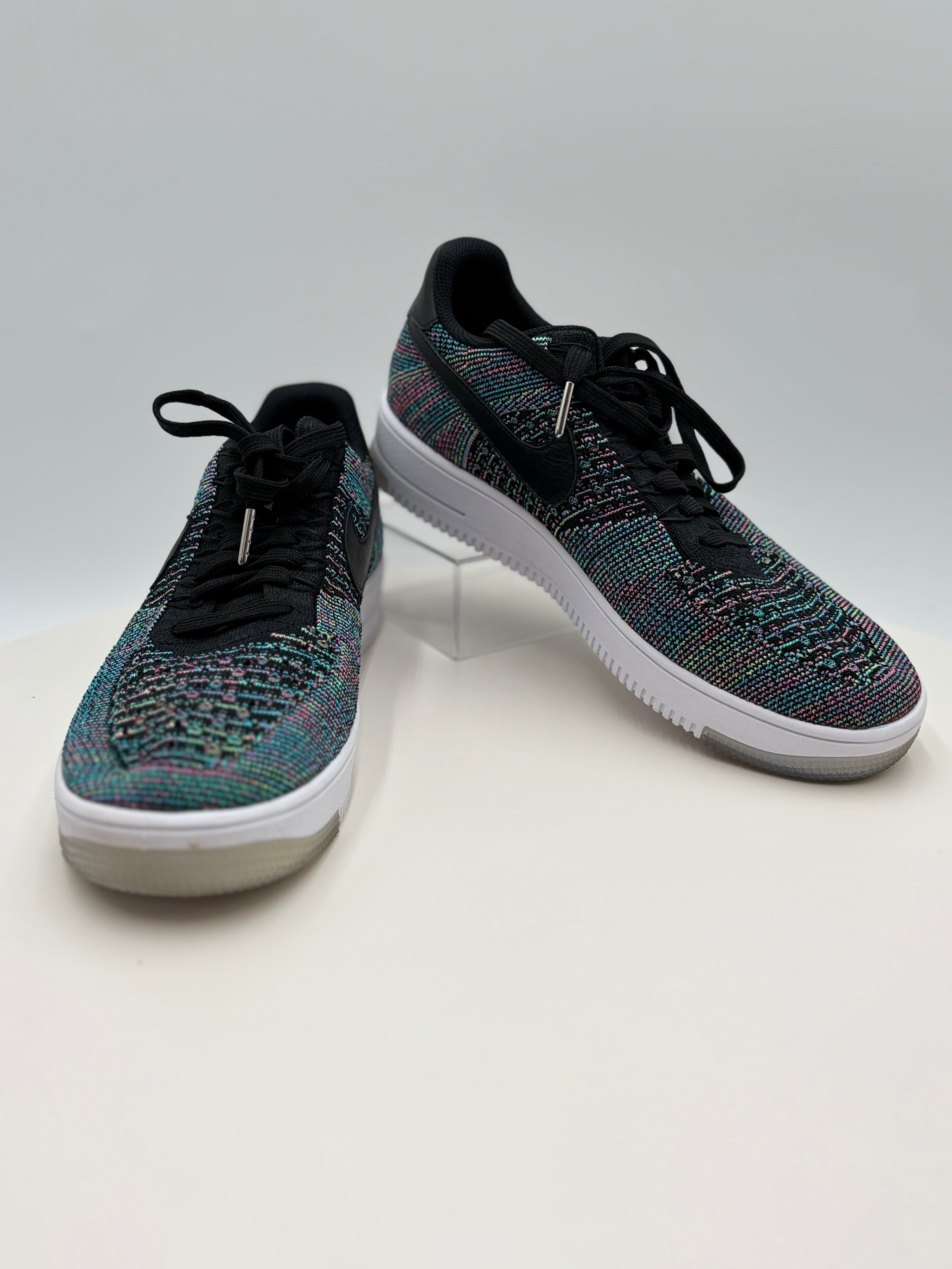 Pair of black and multicolor sneakers on a white background