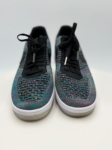 Pair of multicolored sneakers with black laces on a white background