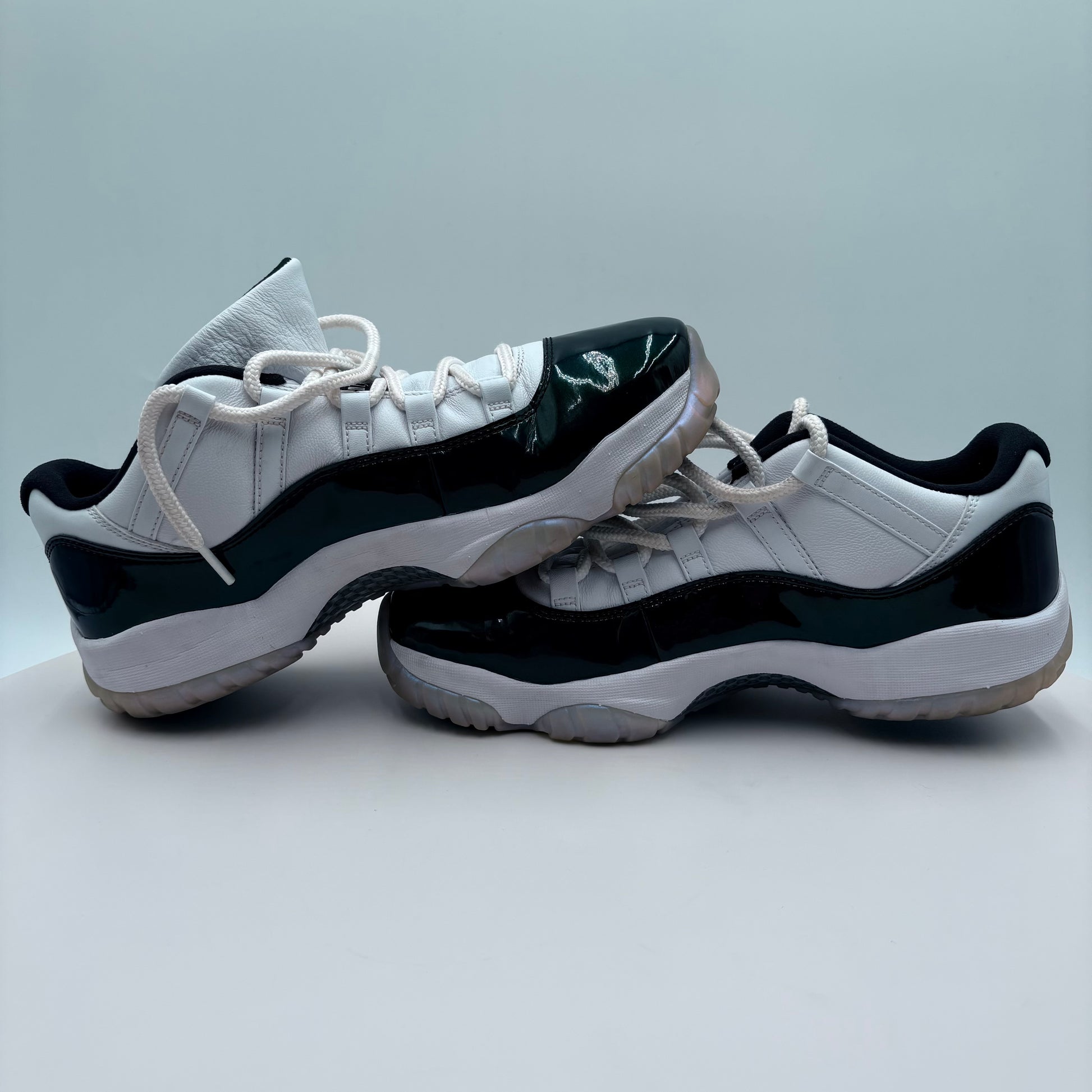 Pair of white and black sneakers on a light gray background