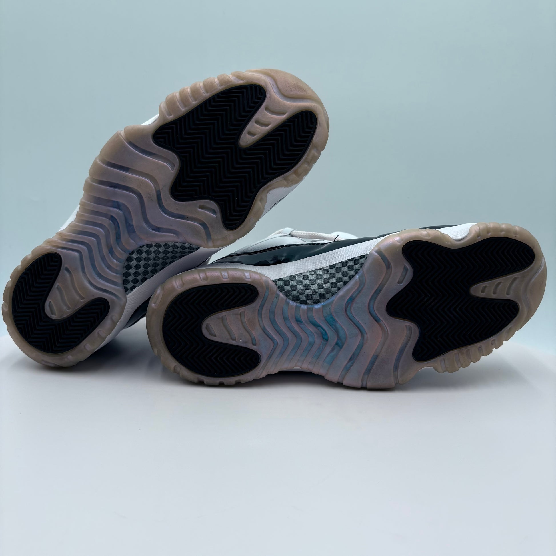 Close-up of a pair of sneakers with a focus on the sole design.