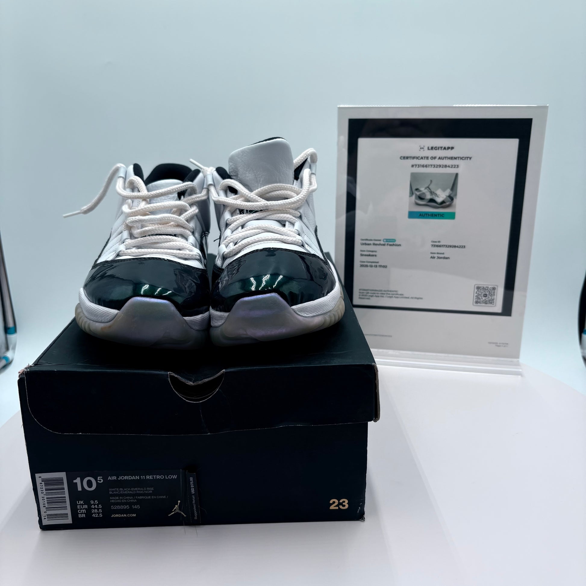 Pair of black and white sneakers on a box with a certificate in the background
