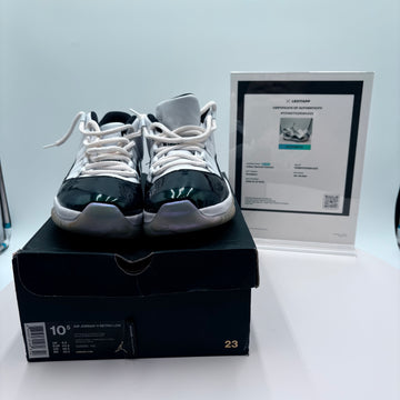 Pair of black and white sneakers on a box with a certificate in the background