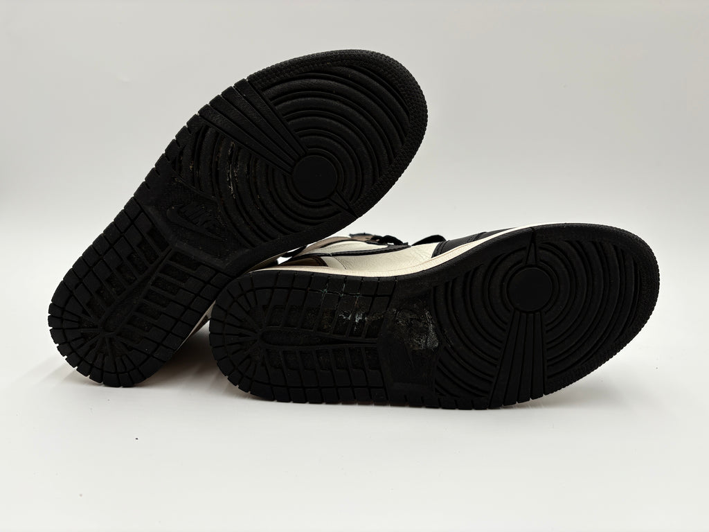 Black soles of  Nike Air Jordan 1 Retro High OG Dark Mocha - sneakers on a white background