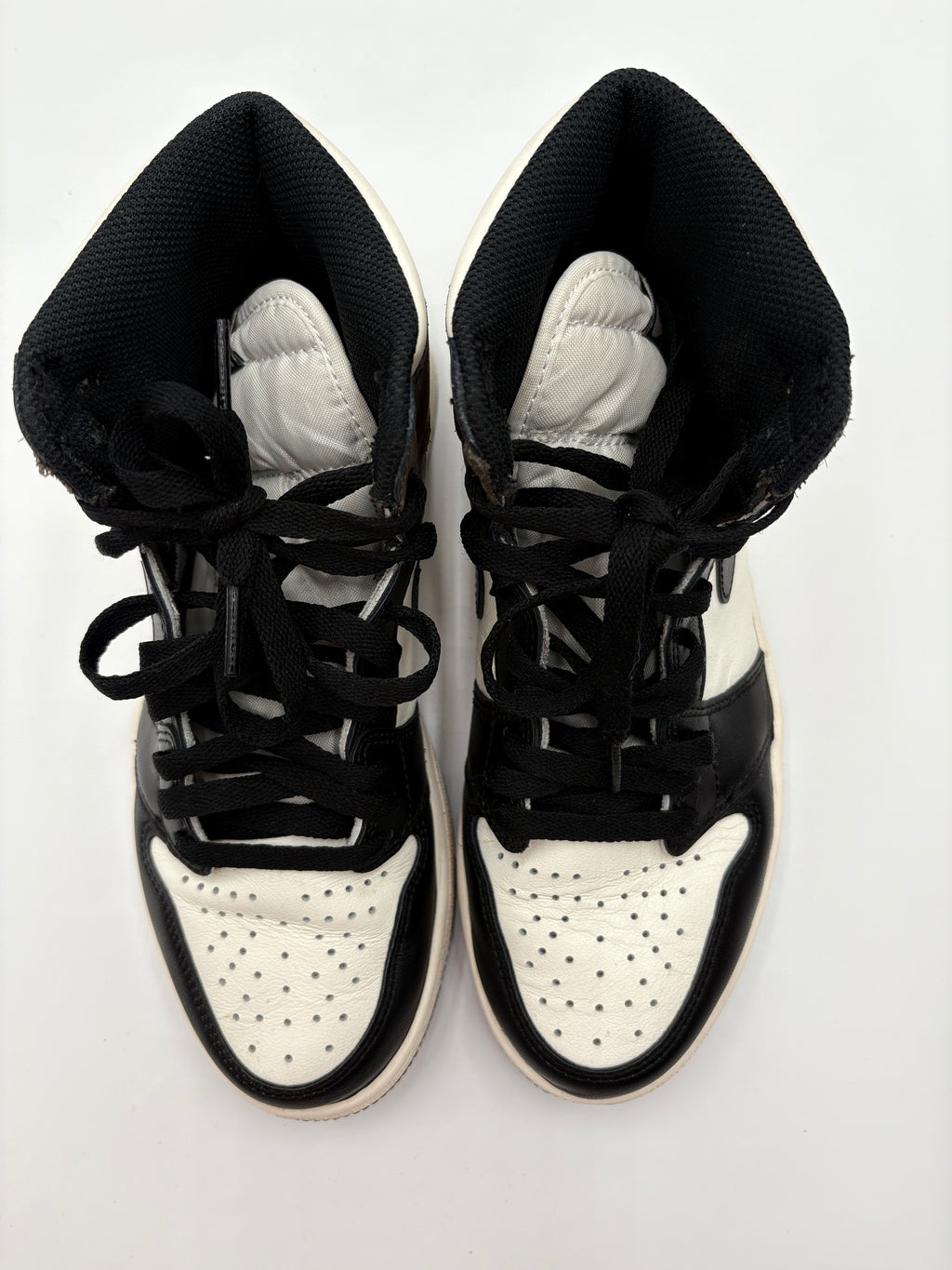 Top view of Nike Air Jordan 1 Retro High OG Dark Mocha - black and white sneakers on a white background