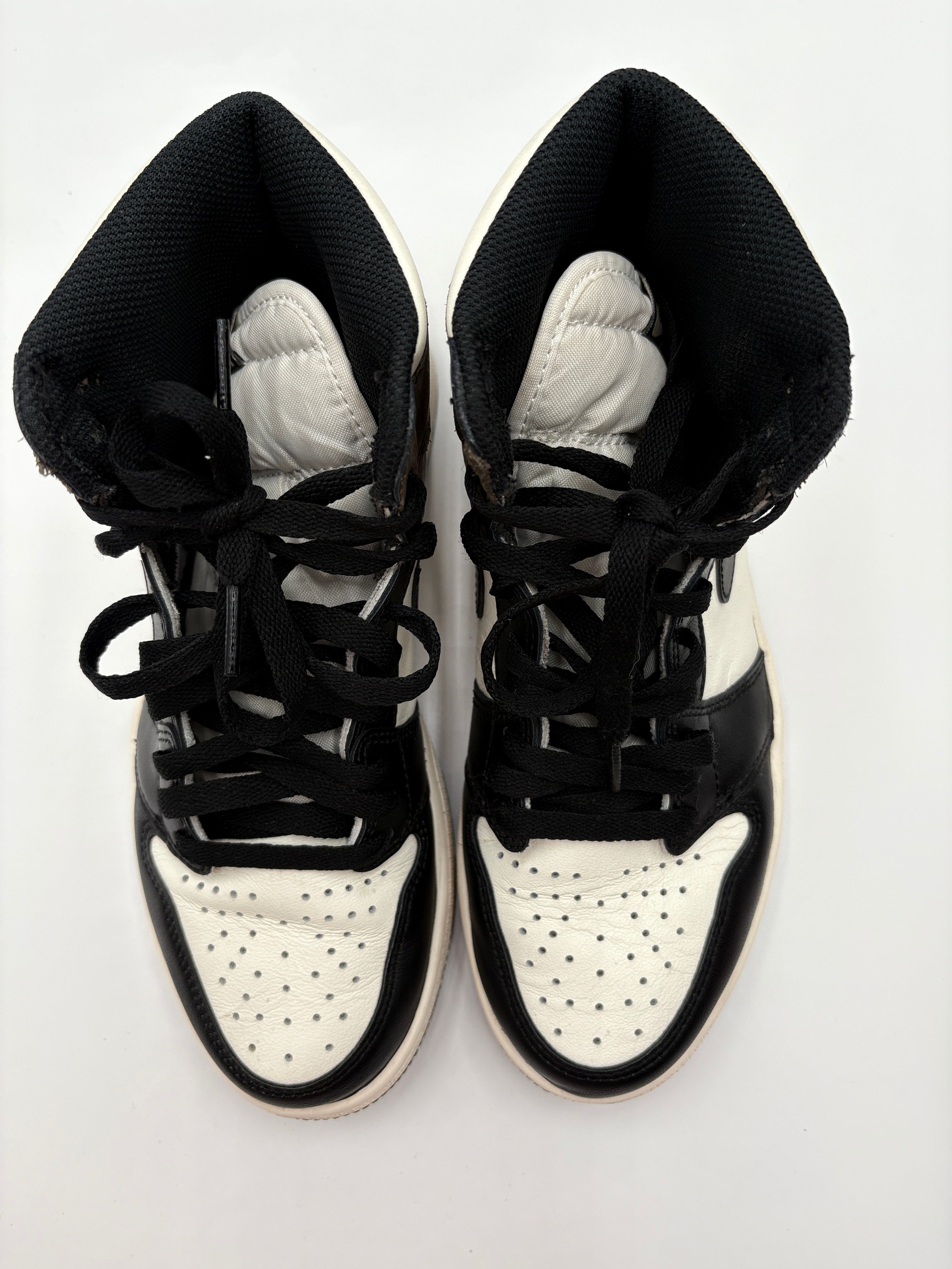 Top view of Nike Air Jordan 1 Retro High OG Dark Mocha - black and white sneakers on a white background